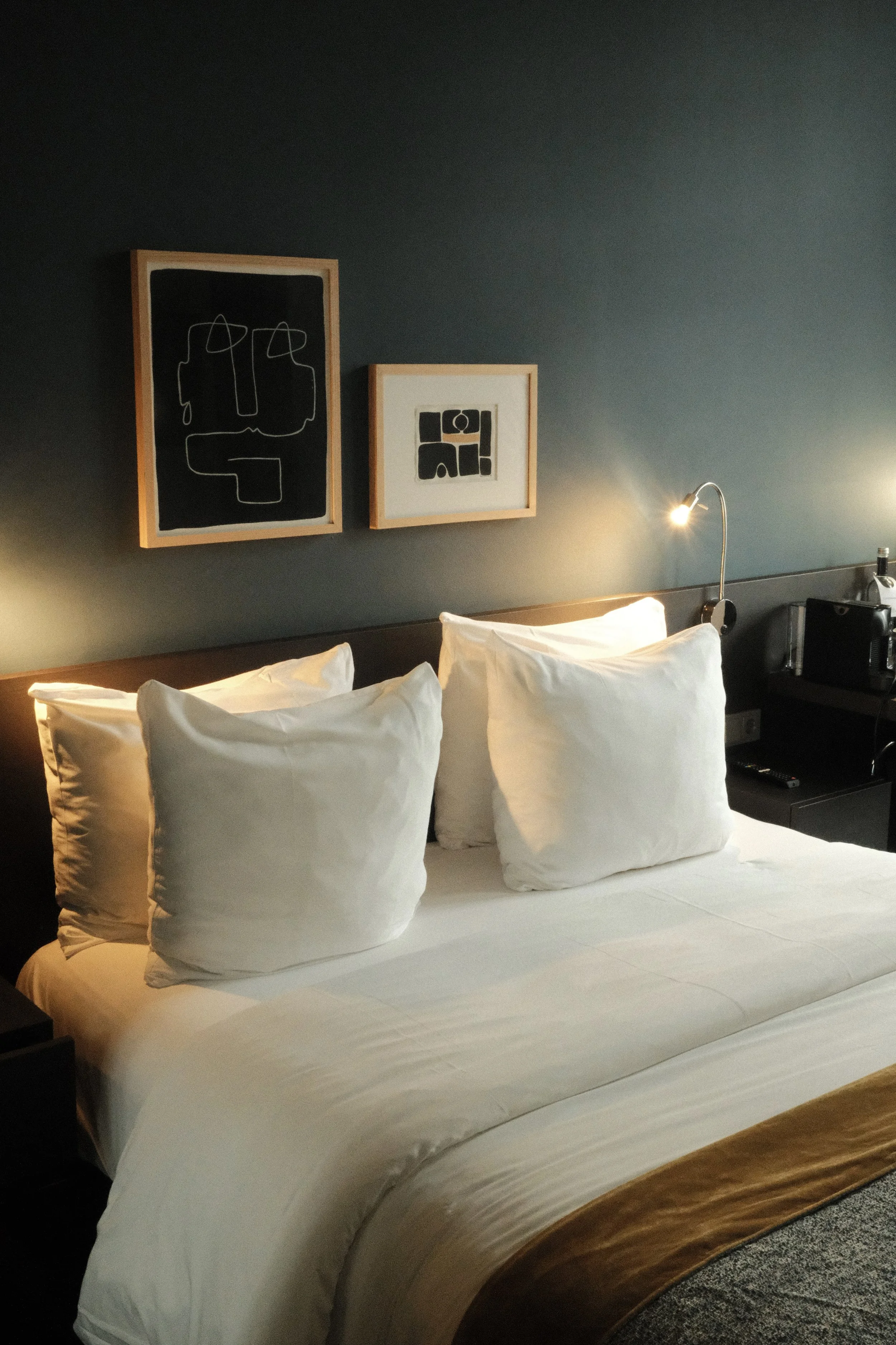 Contemporary king guest room with plush bedding, modern artwork, and ambient lighting