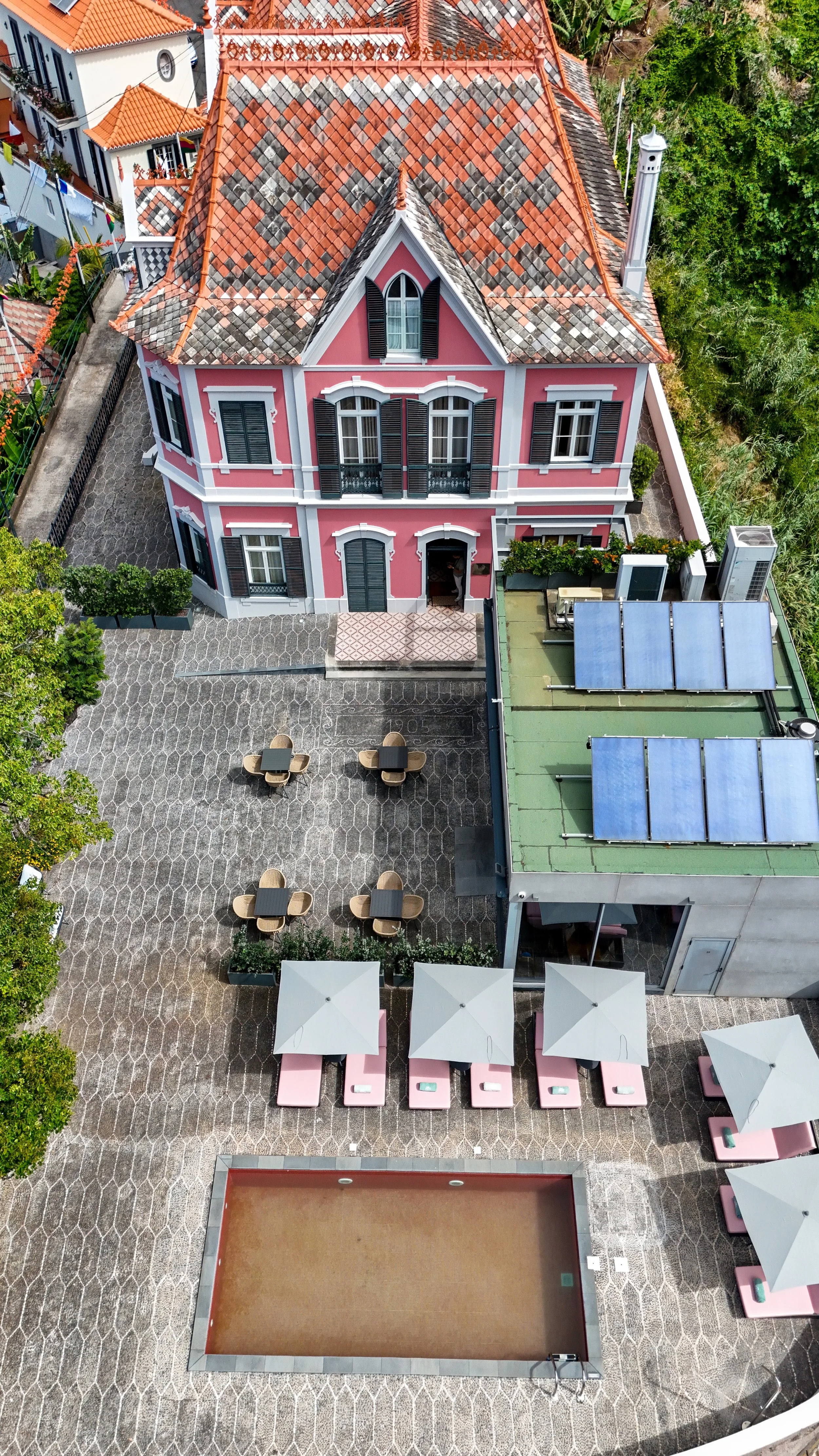 Aerial view of the boutique hotel highlighting its historic architecture, courtyard, and outdoor pool