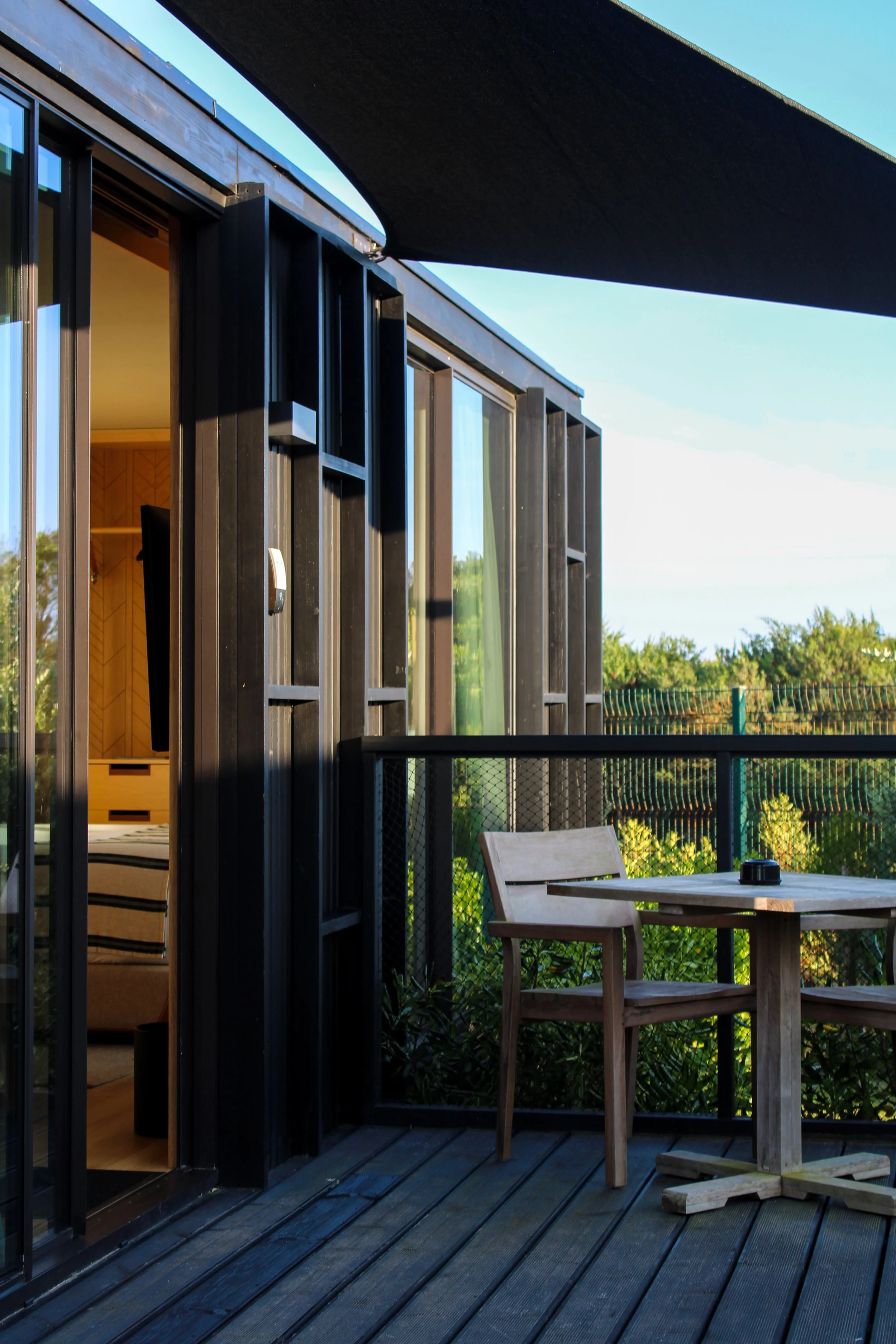 Private outdoor terrace with shaded seating overlooking peaceful surroundings