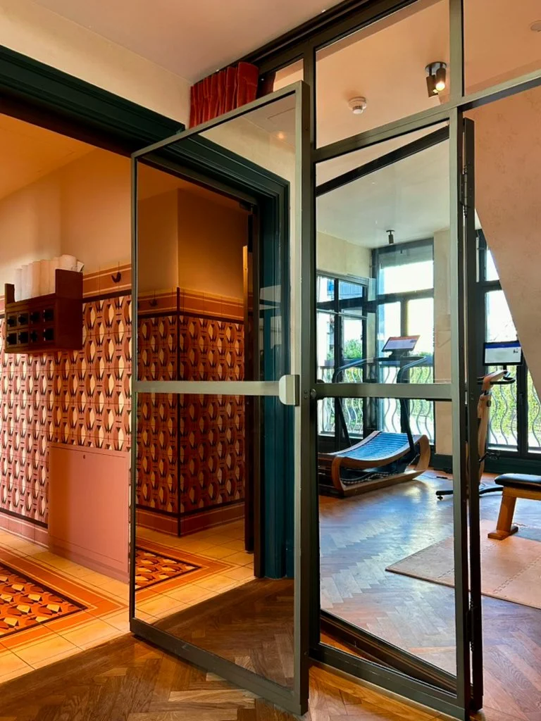 Modern fitness room with natural light and contemporary equipment