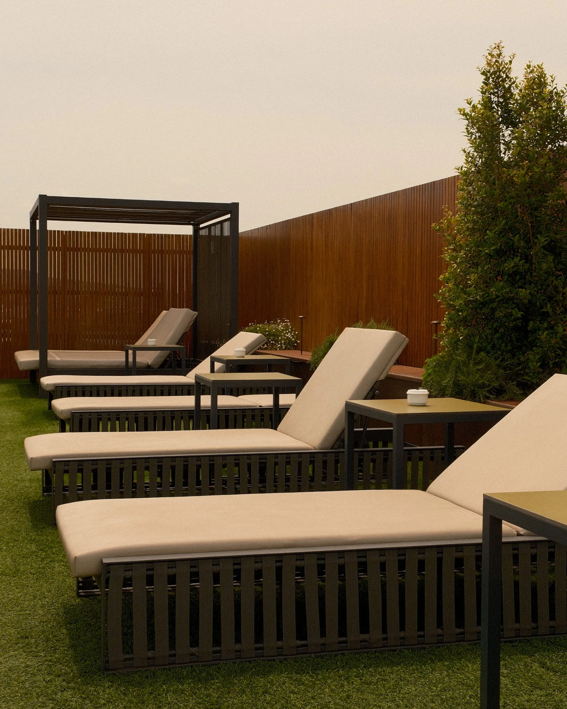 Rooftop sun loungers and relaxation area at Sallés Hotel Pere IV