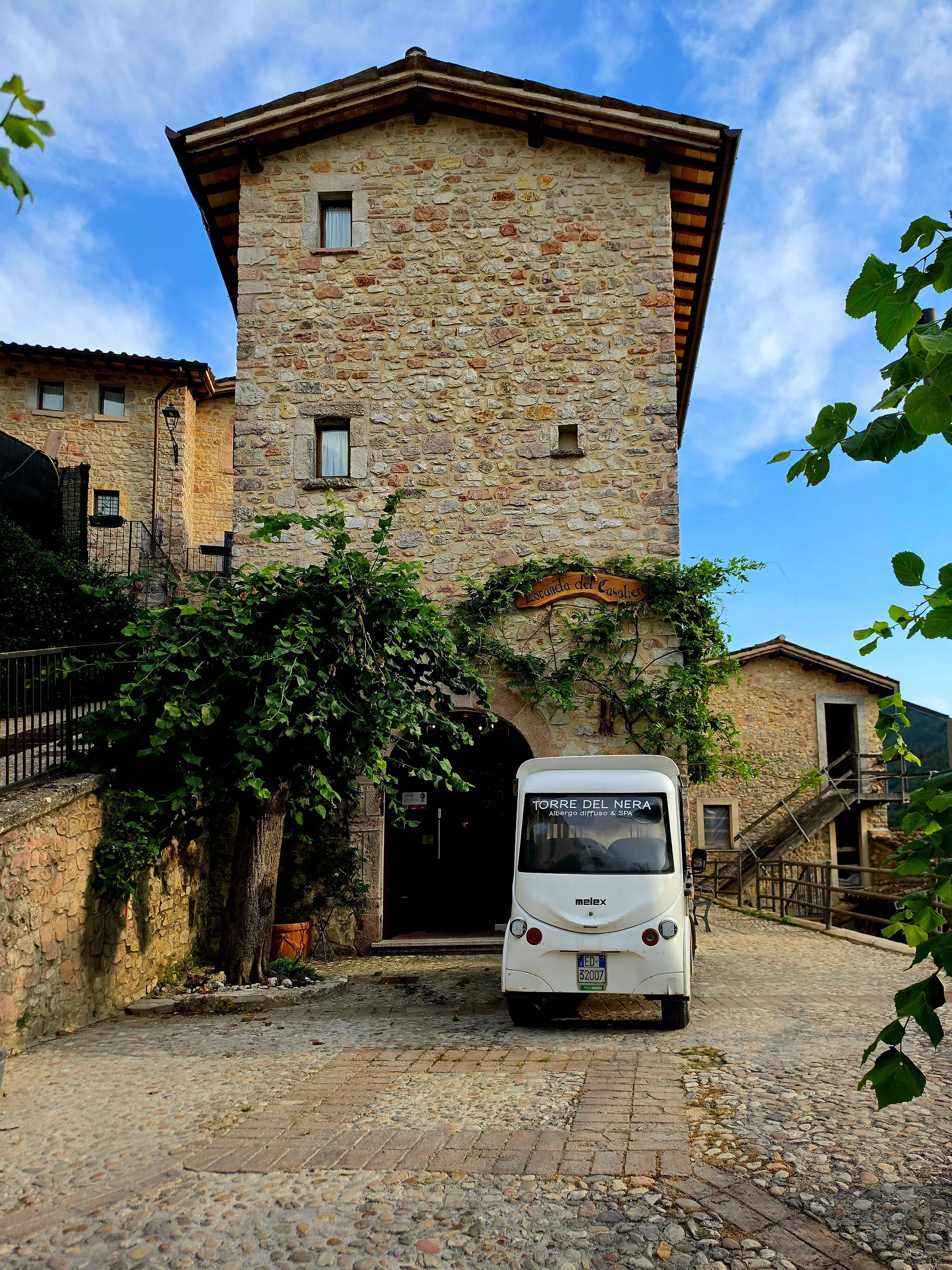 Historic stone buildings welcoming guests into the peaceful village square