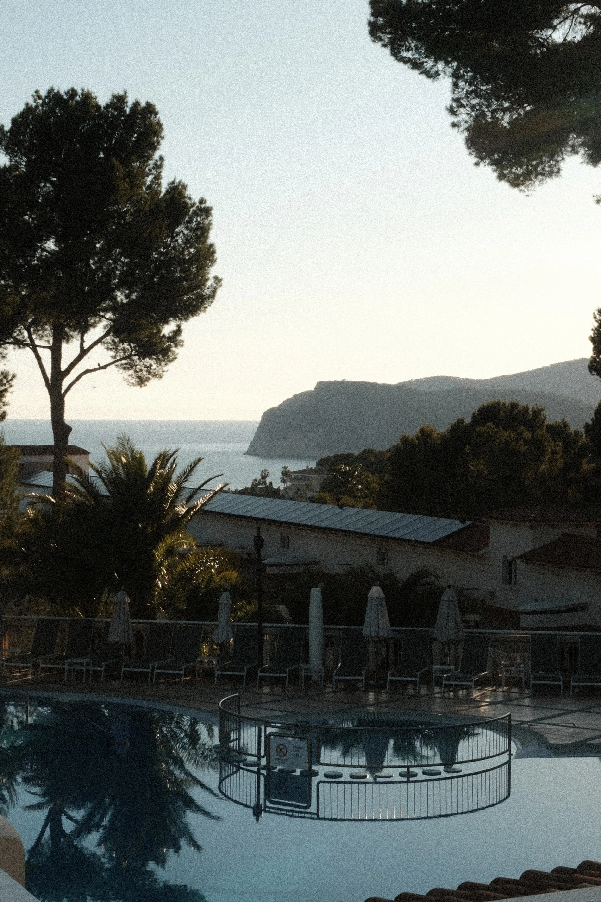 Sunset views over the Mediterranean Sea and surrounding hills from the pool area at Hilton Mallorca Galatzo