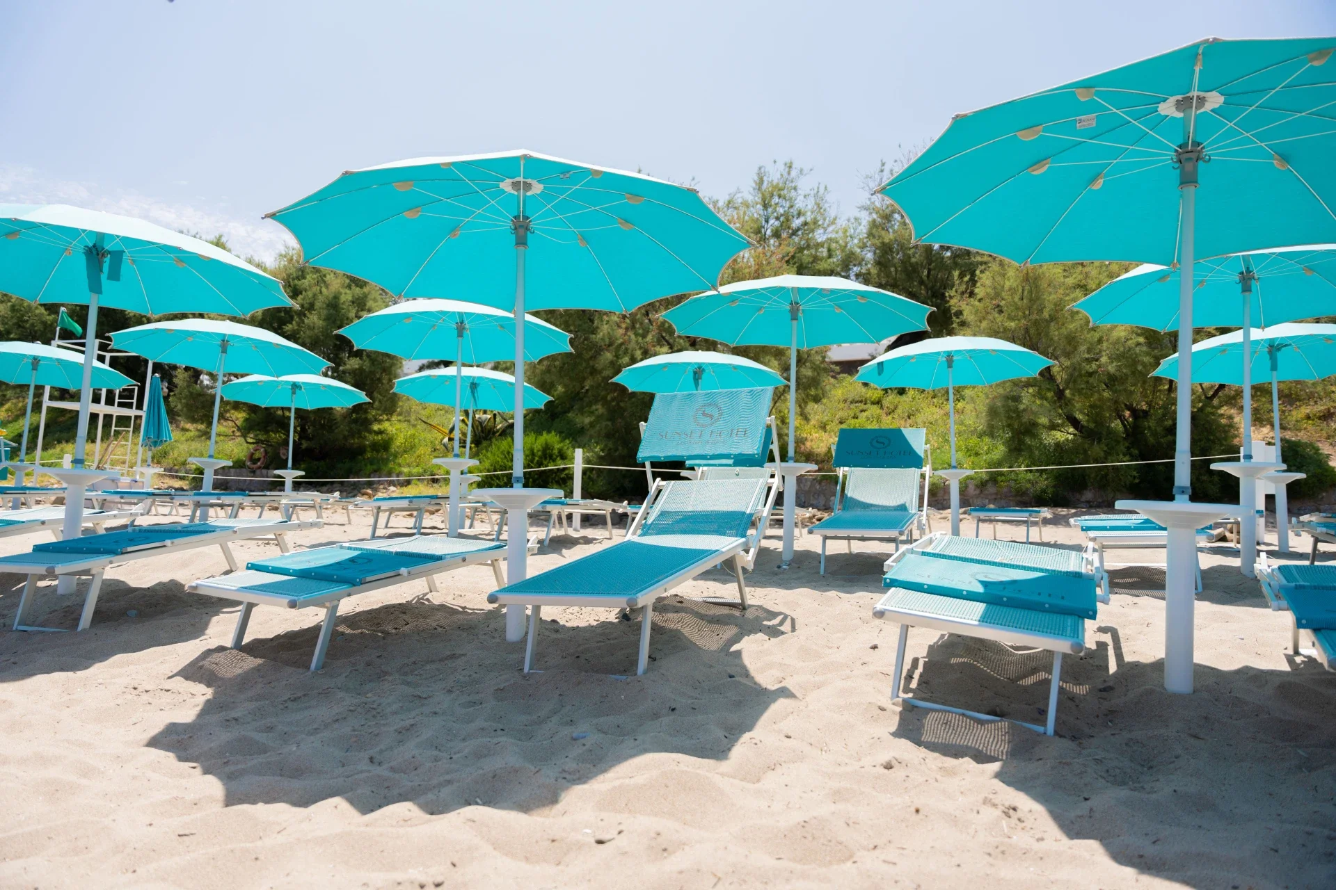 Beach loungers and umbrellas on the private beach at Sunset Hotel Cefalù
