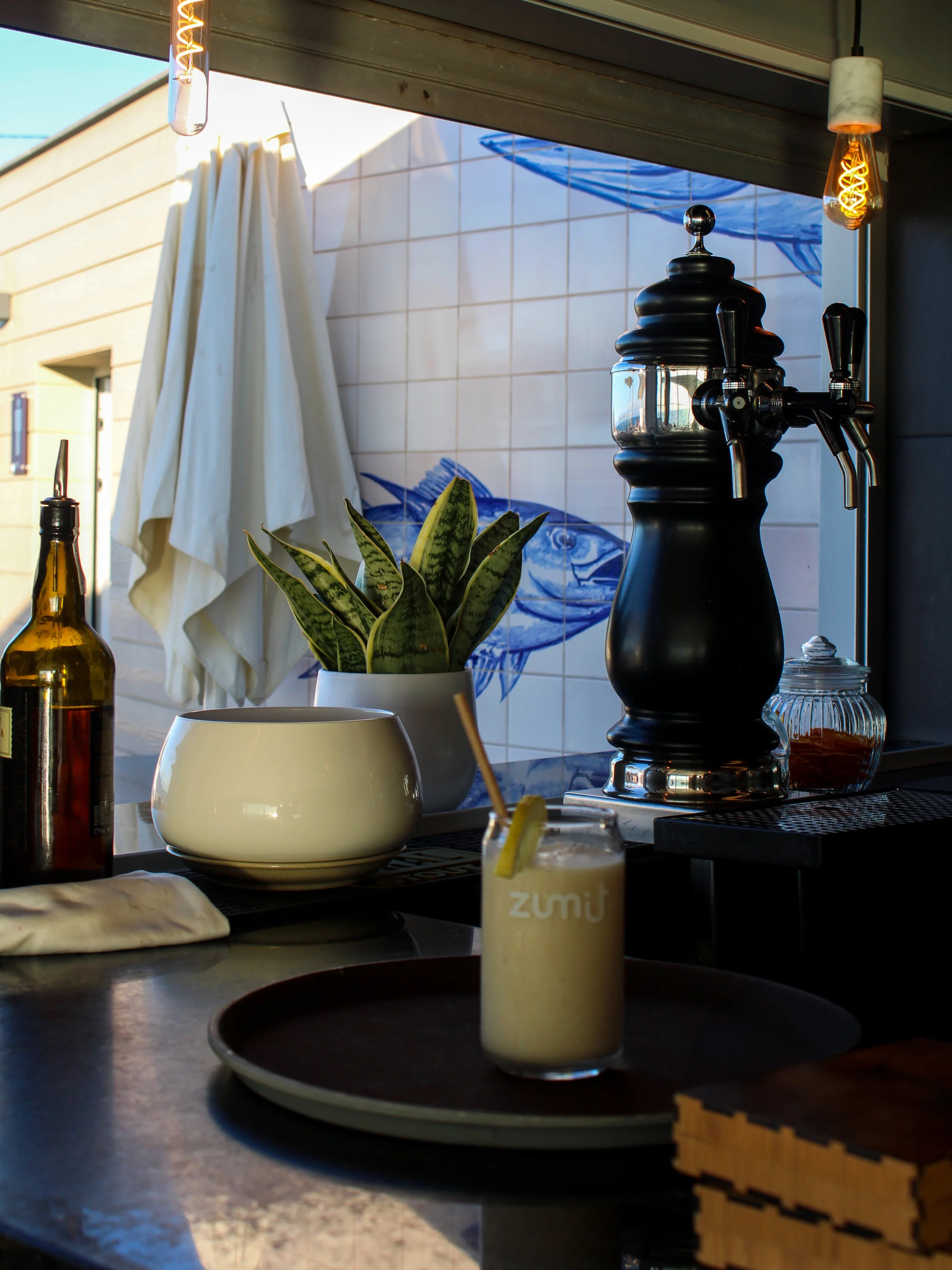 Signature cocktail served at the stylish hotel bar with contemporary décor and artistic Madeiran details
