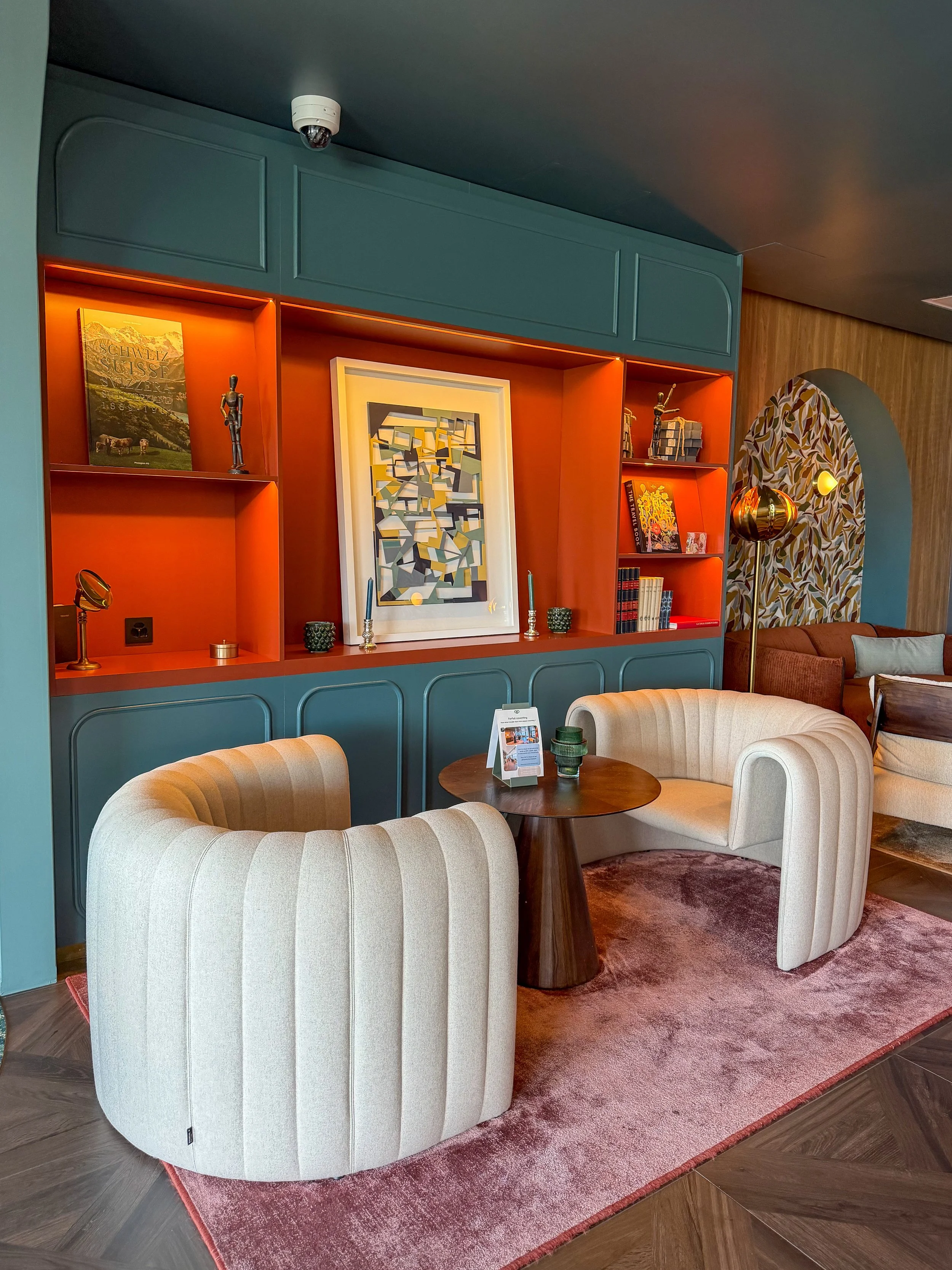 Comfortable lounge with contemporary furnishings, curated artwork, and warm designer interiors