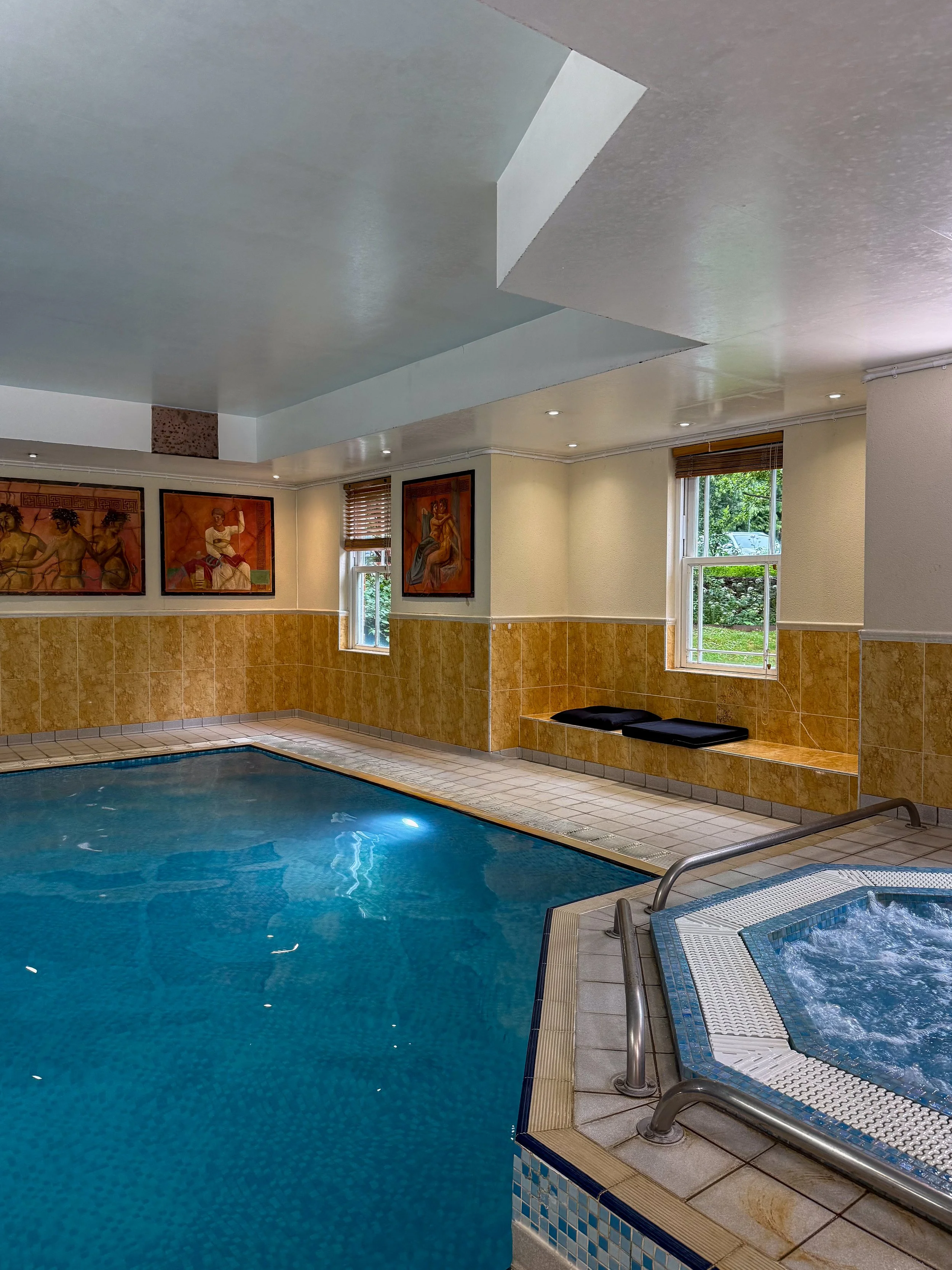 Indoor swimming pool and whirlpool offering relaxation within the wellness facilities