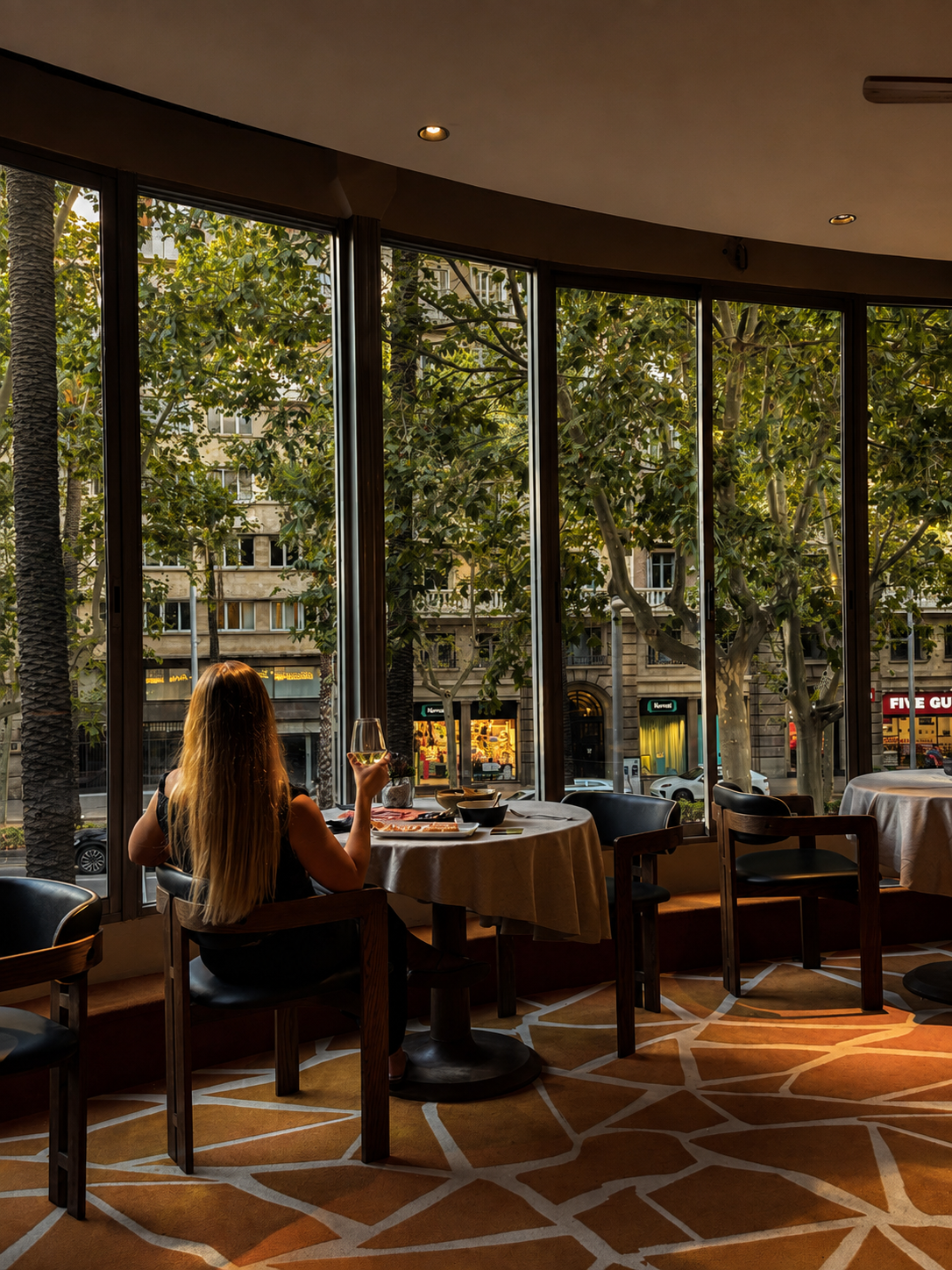 Restaurant dining room overlooking the tree-lined streets of Barcelona
