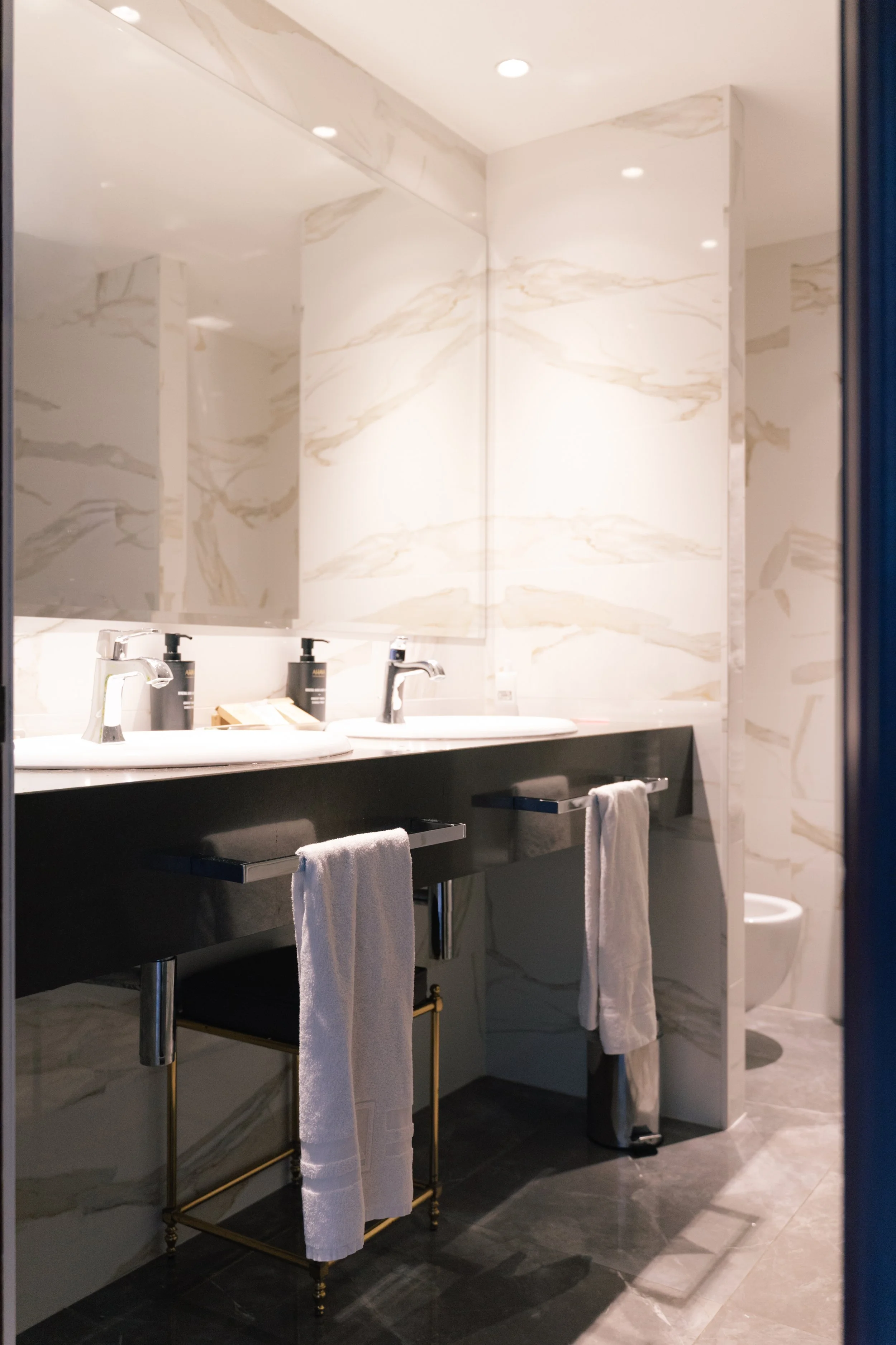 Modern marble bathroom with double sink and minimalist design at Eurostars Hotel Real