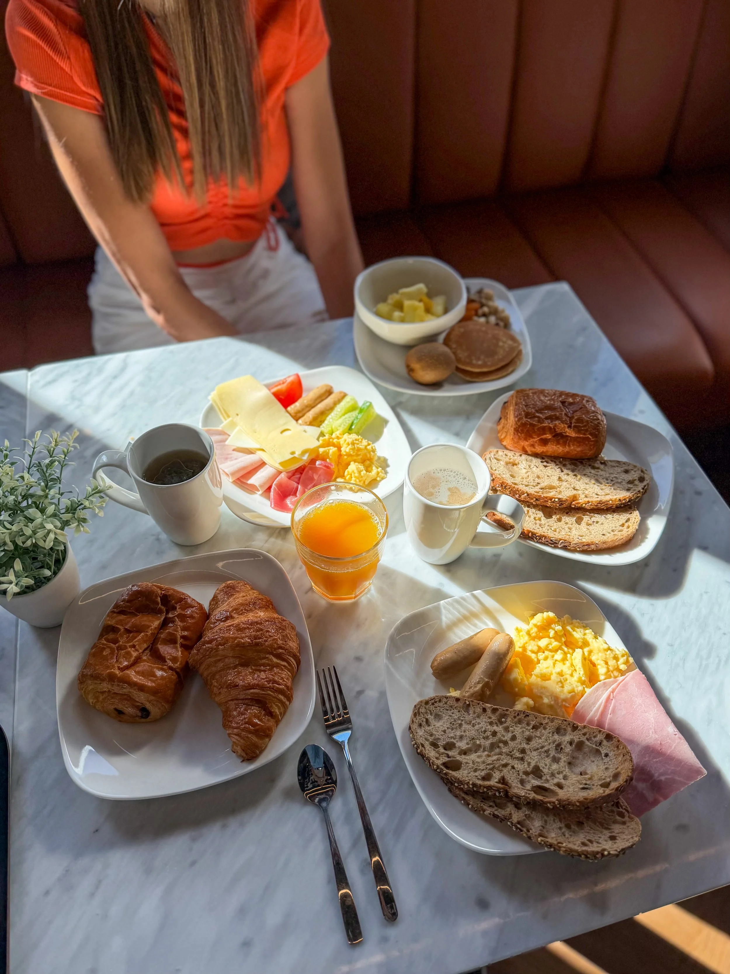 Continental breakfast with fresh pastries, eggs, fruit, coffee, and juice in the hotel lounge