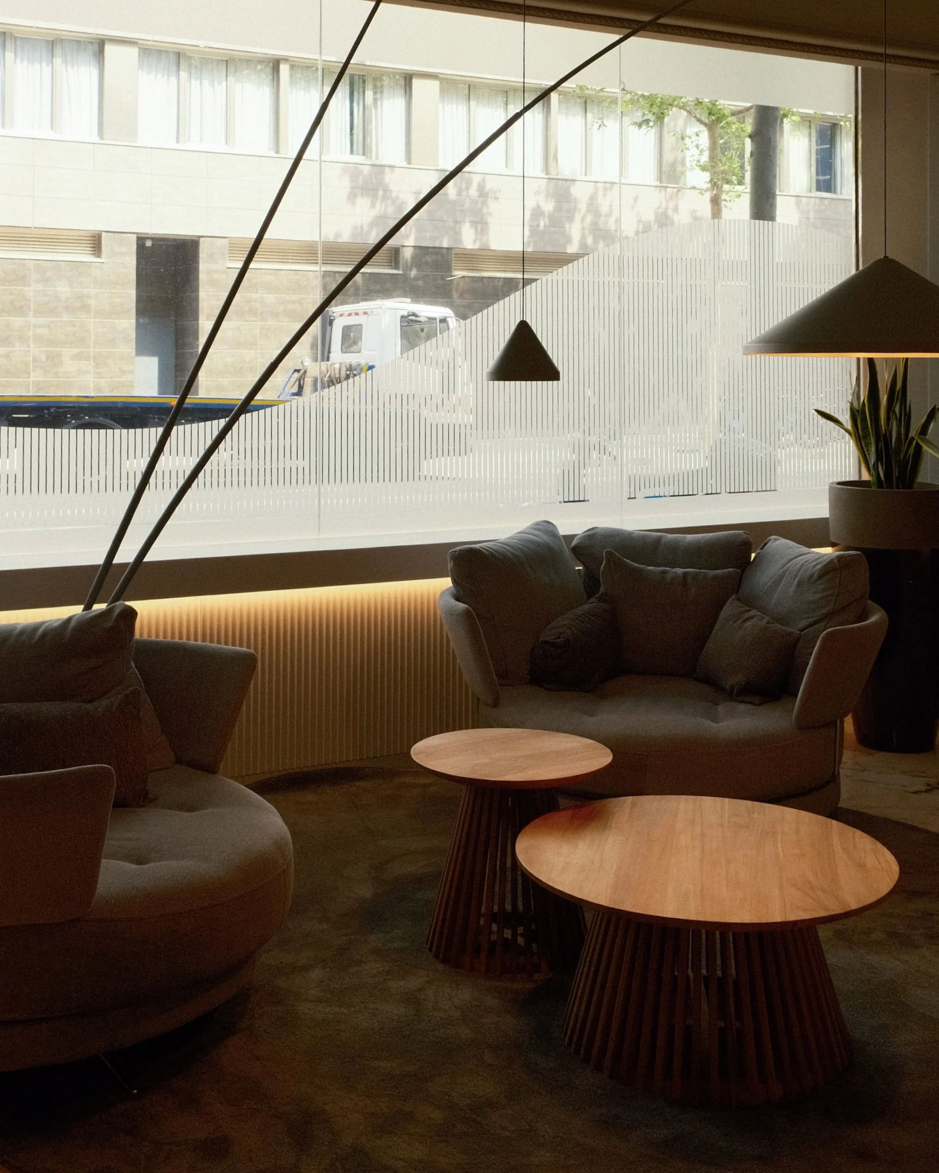 Modern lounge area with designer seating and floor-to-ceiling windows