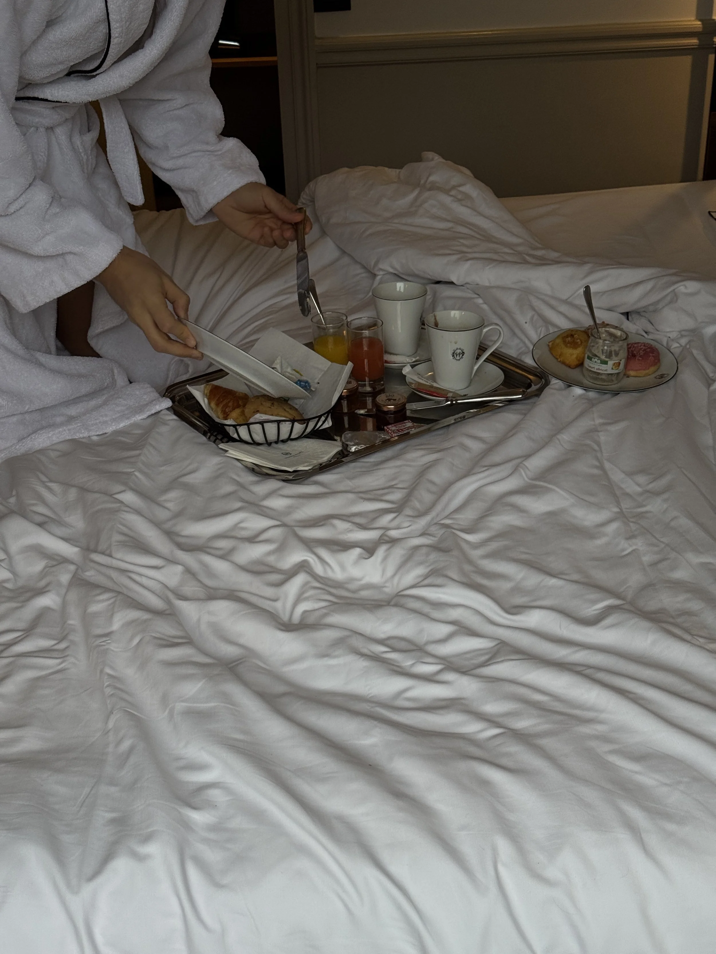 In-room breakfast served on crisp white linens with pastries, coffee, and fresh juices, Victoria Palace Hotel – Paris, France.