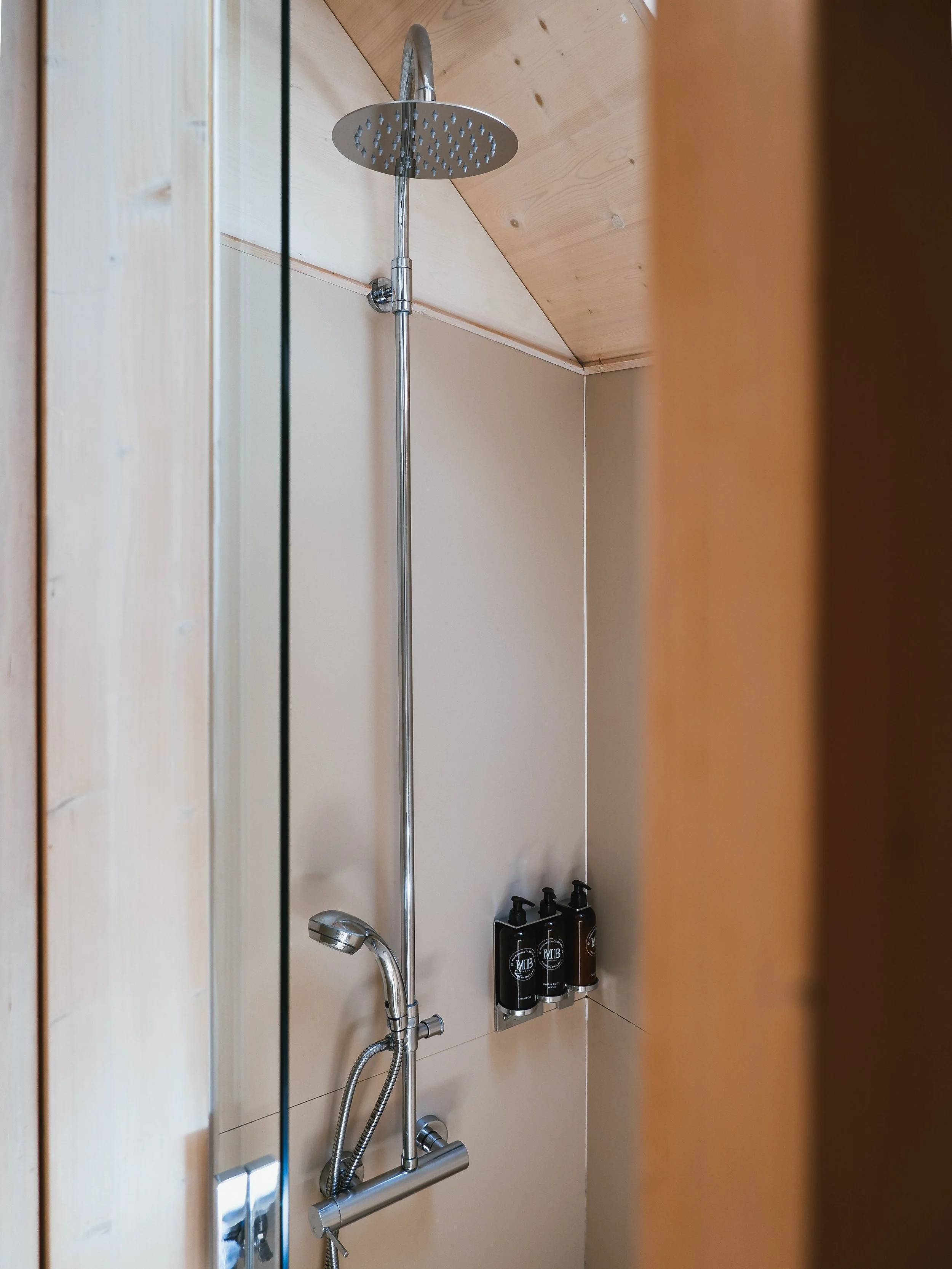 Modern rainfall shower with premium amenities inside the contemporary eco cabin