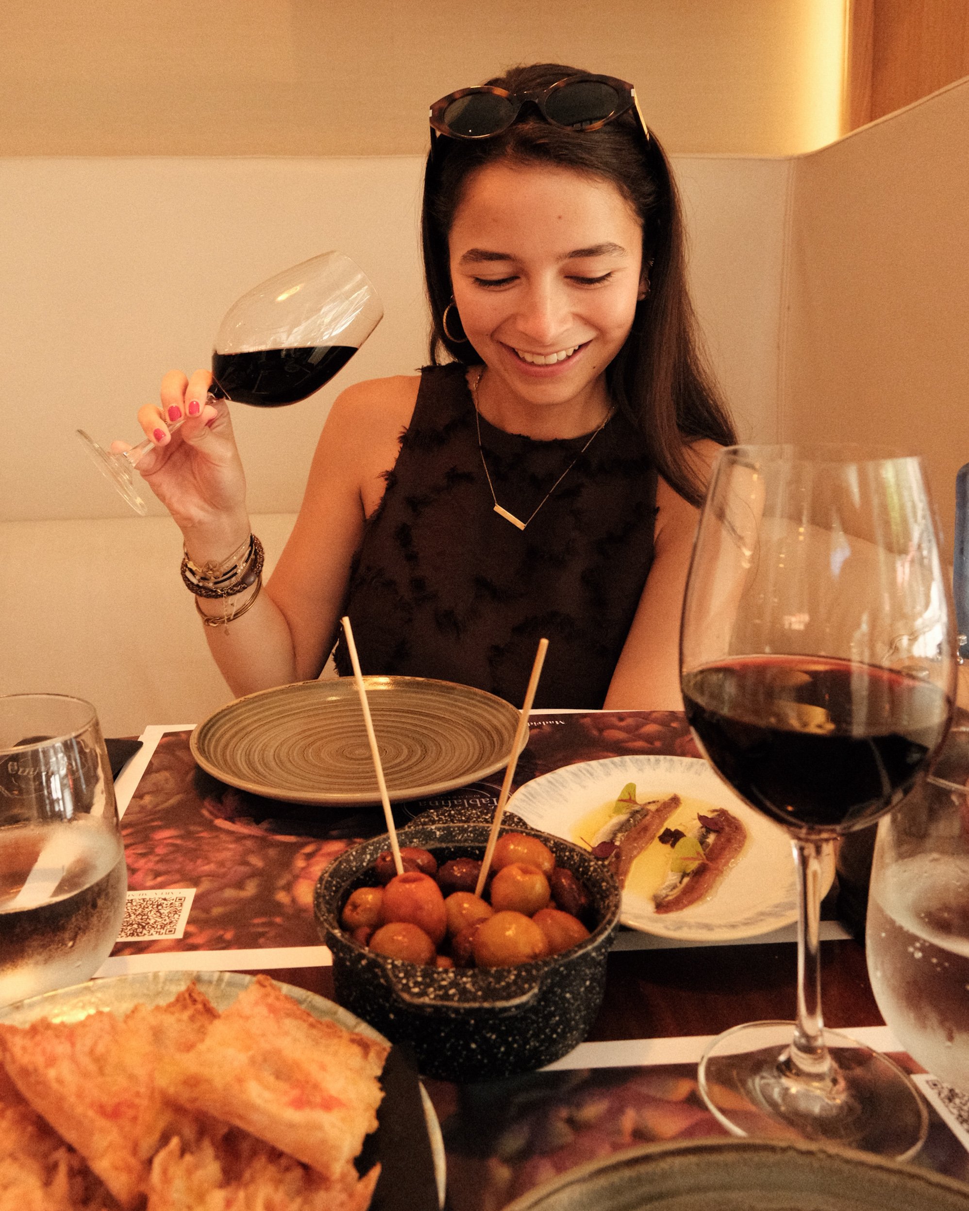 Guest enjoying Mediterranean tapas and wine at the hotel’s restaurant