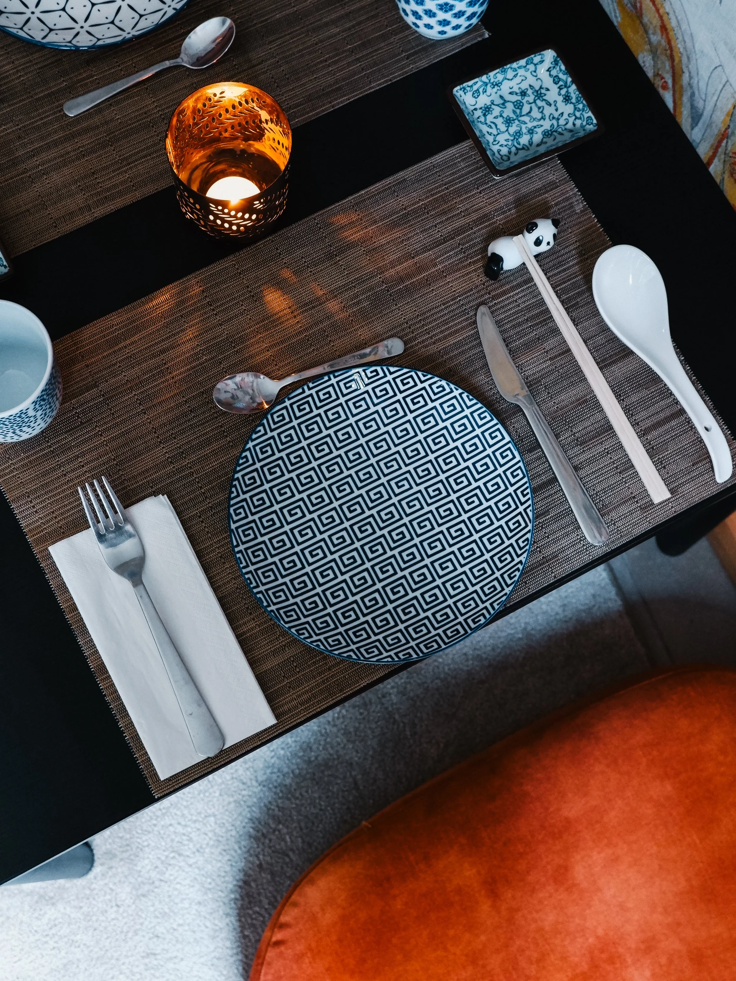 Beautifully arranged Japanese table setting with handcrafted ceramics and ambient candlelight