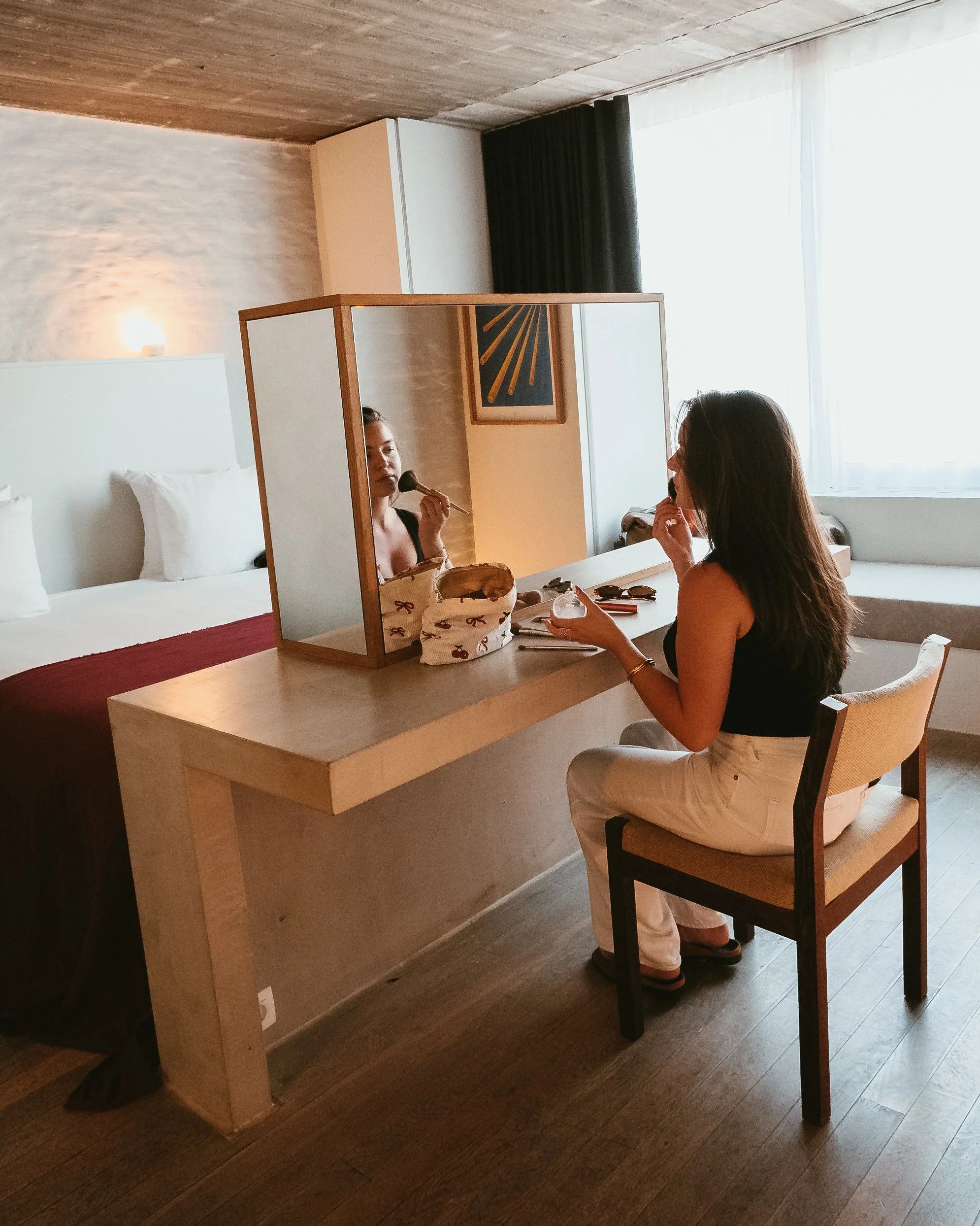 Guest getting ready at the spacious vanity inside the contemporary suite