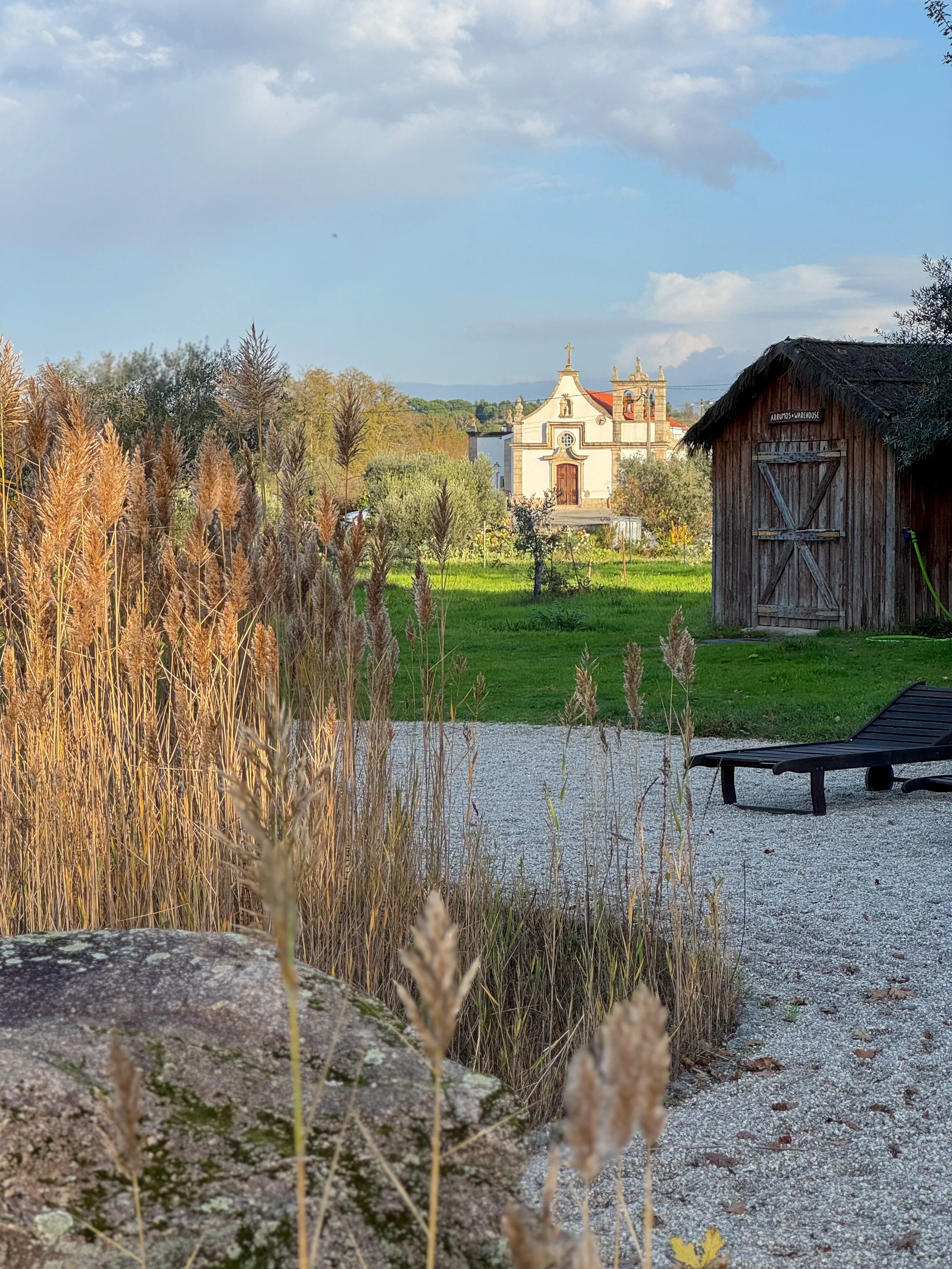 Peaceful countryside view with chapel, gardens, and natural landscapes surrounding Chão do Rio