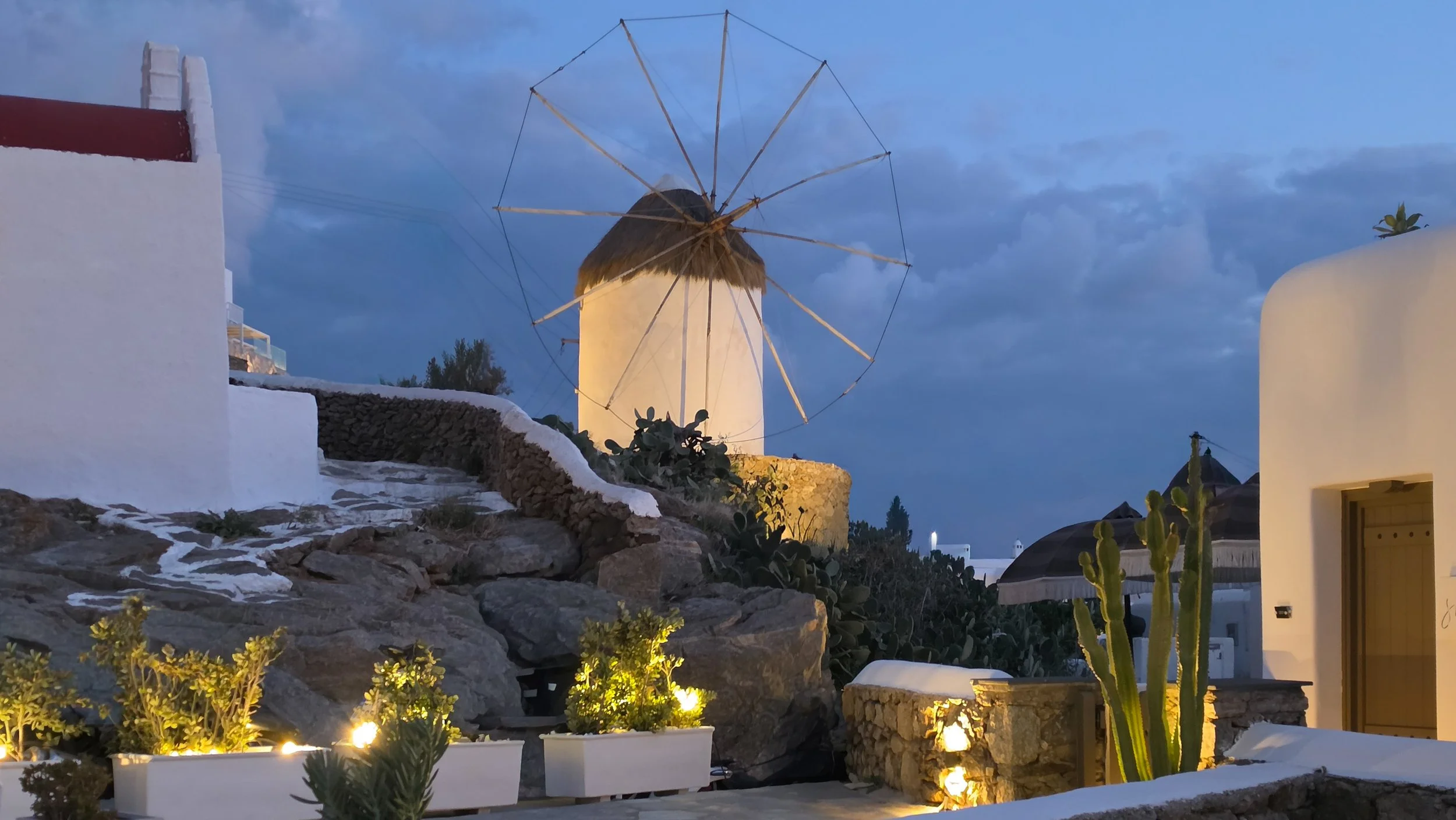 Traditional Mykonos windmill near She Mykonos Hotel at dusk in Mykonos, Greece