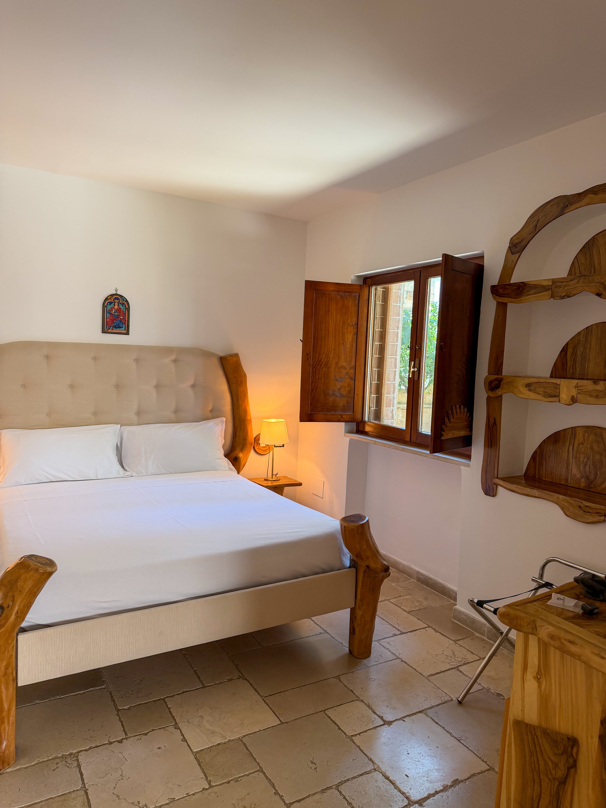 Rustic guest room featuring handcrafted wooden furnishings and authentic Apulian design at Tenute Al Bano