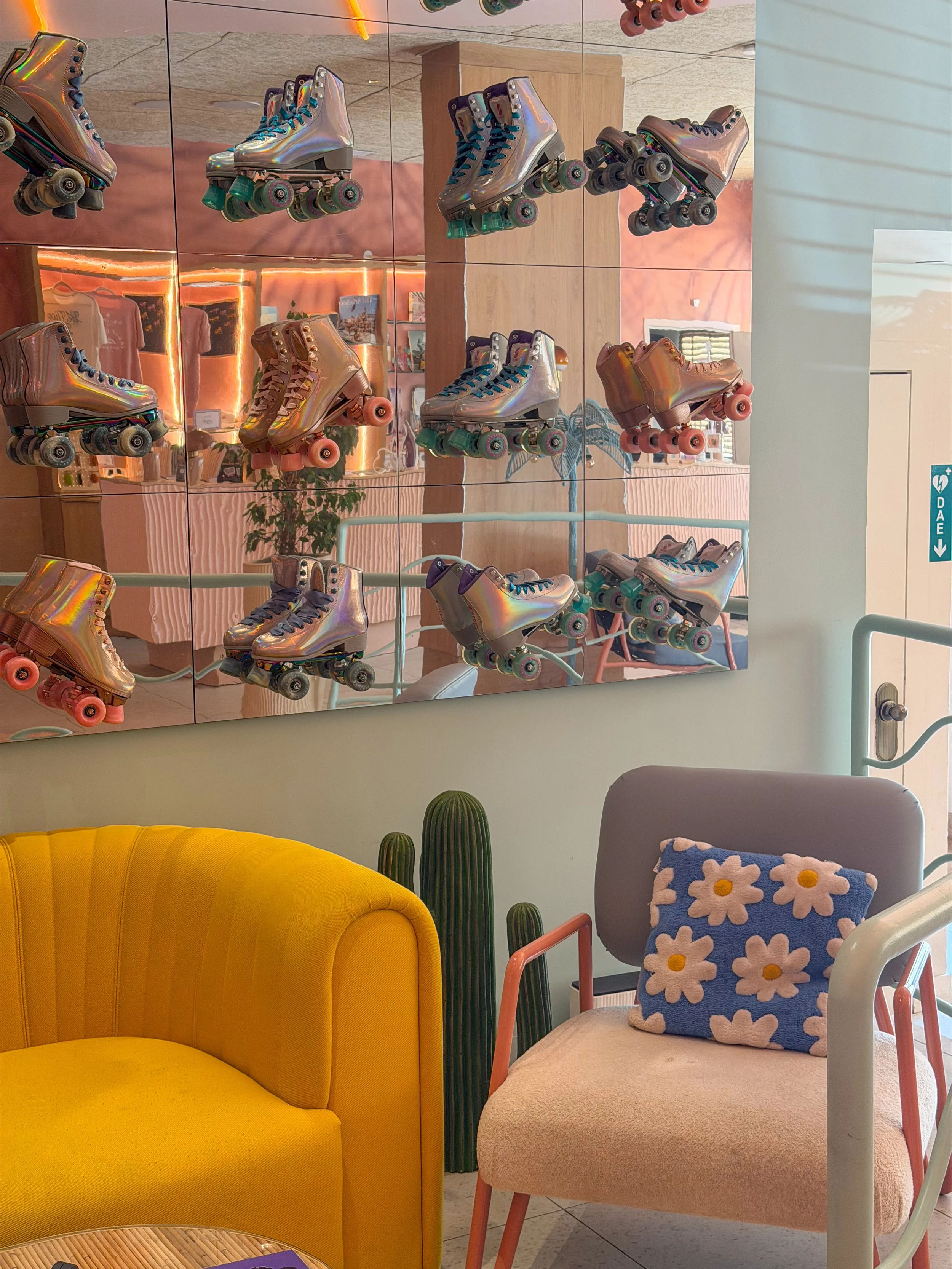 Colorful retro interior with metallic roller skates displayed on mirrored wall panels