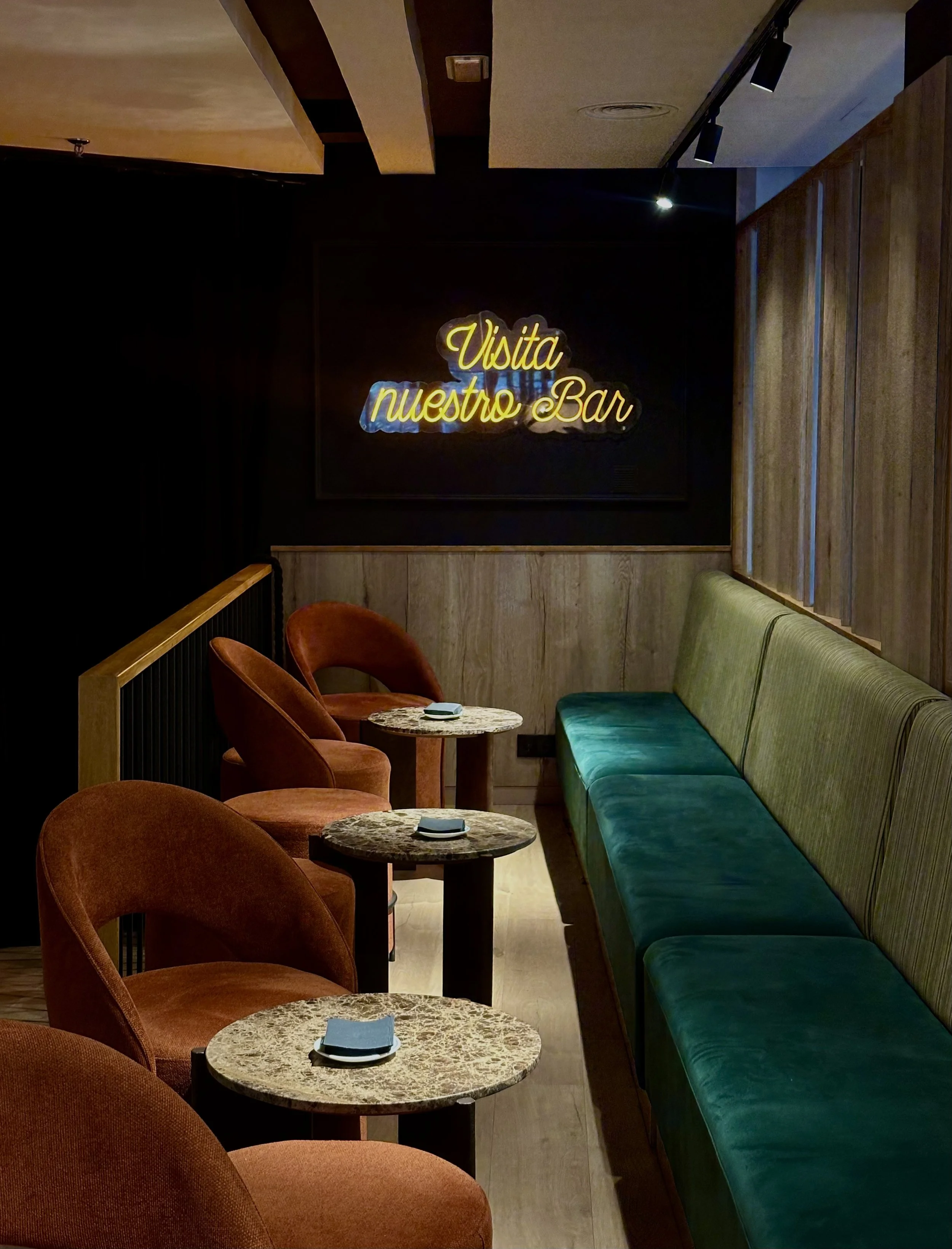 Contemporary cocktail lounge with velvet seating and ambient evening lighting