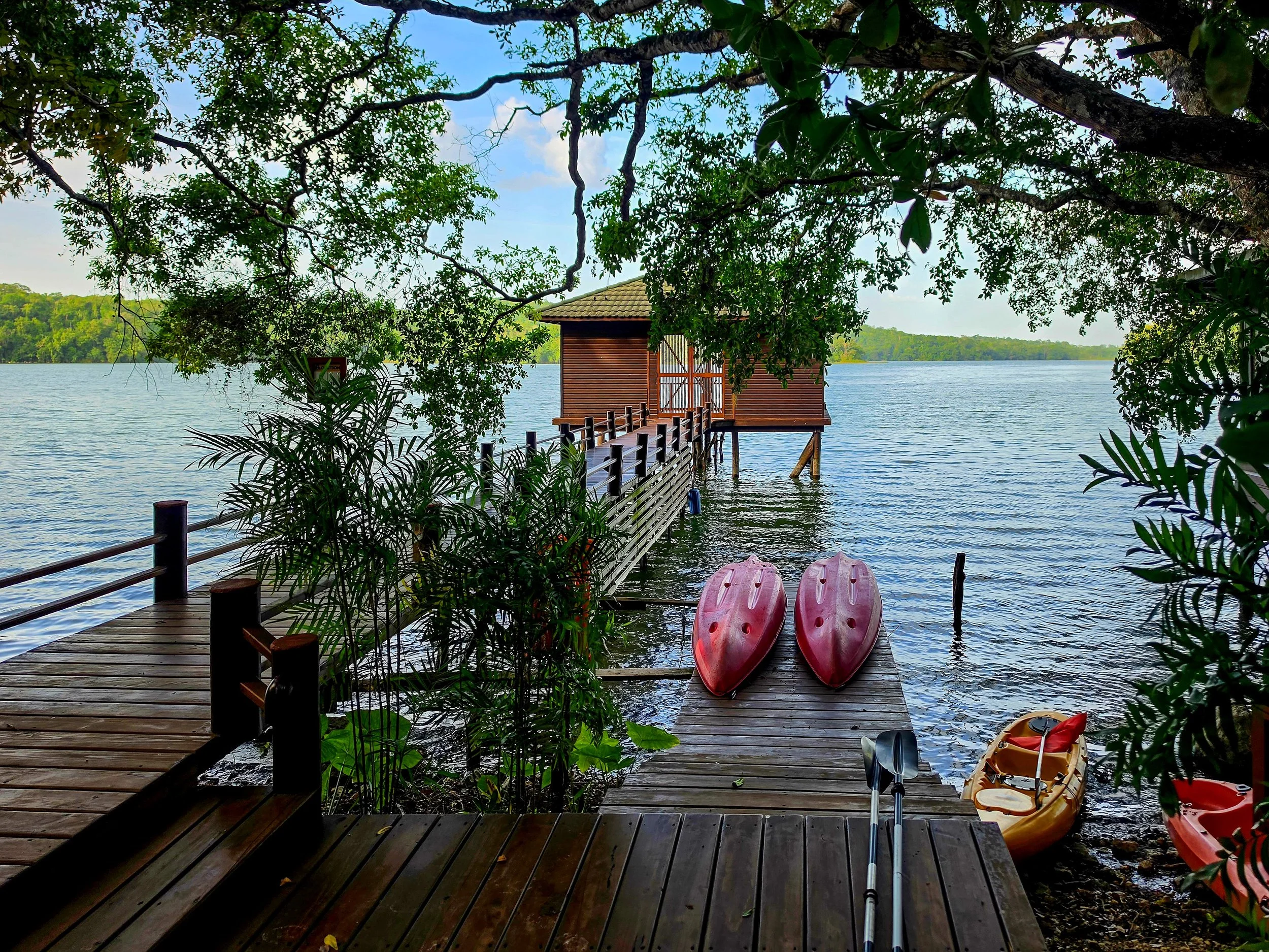 Private wooden pier with kayaks overlooking the peaceful lagoon