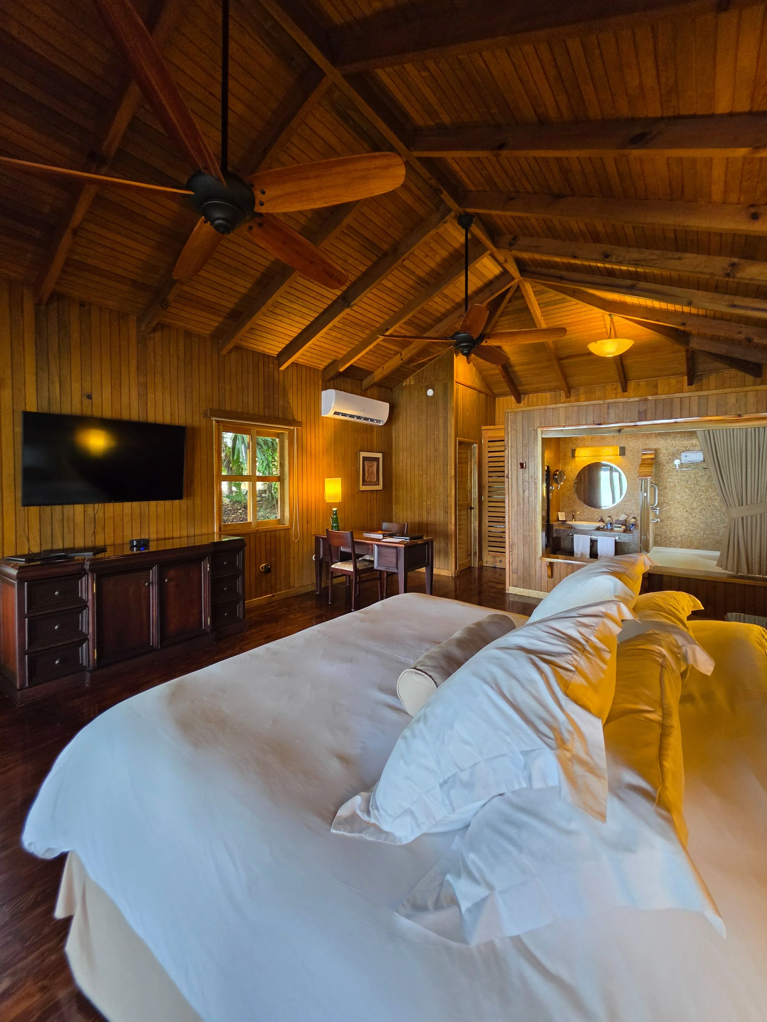 Spacious wooden suite featuring vaulted ceilings and warm natural finishes.