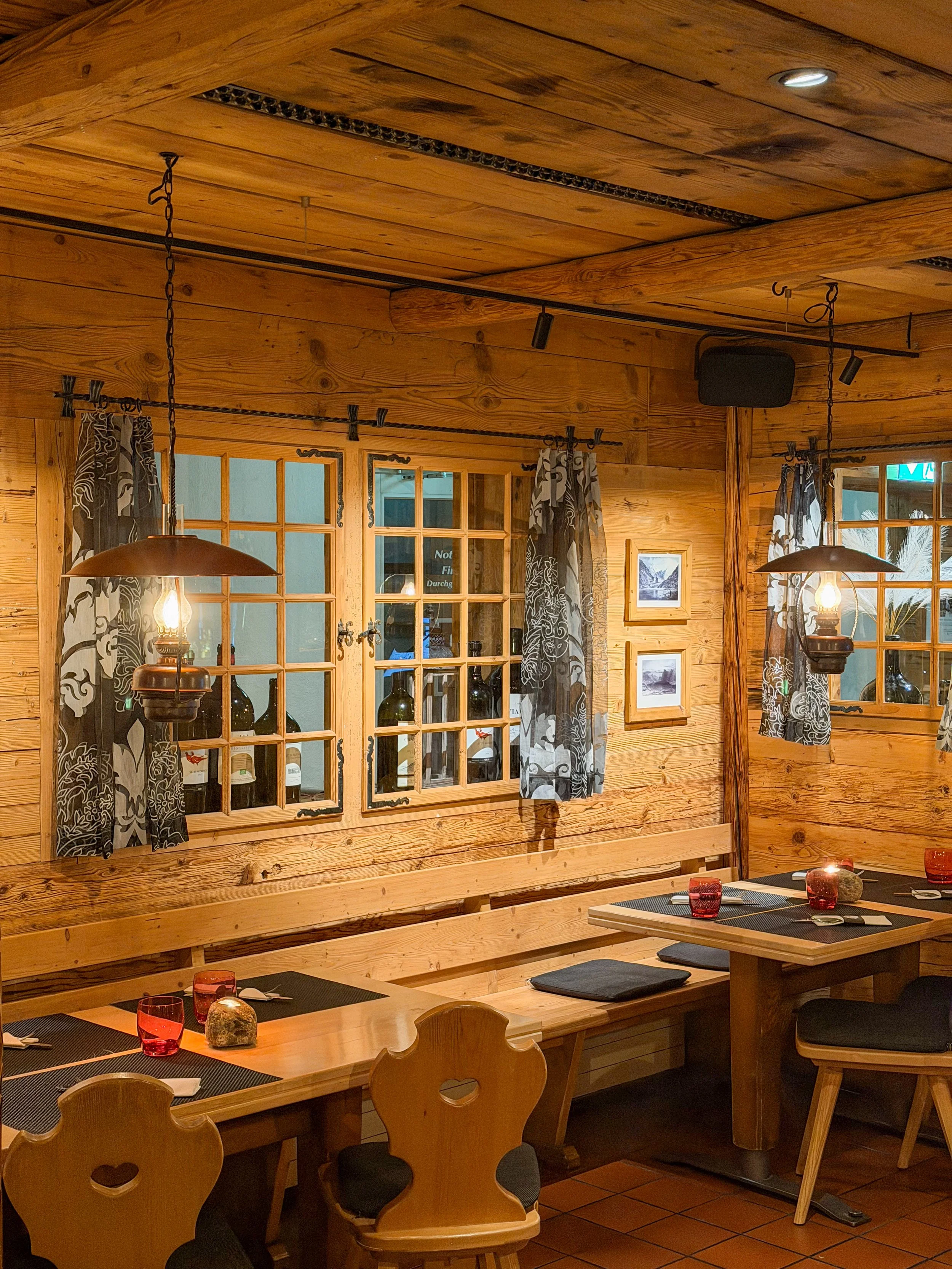 Rustic Swiss restaurant with timber interiors, warm lighting and authentic alpine character at Eiger Mountain & Spa Soul Resort