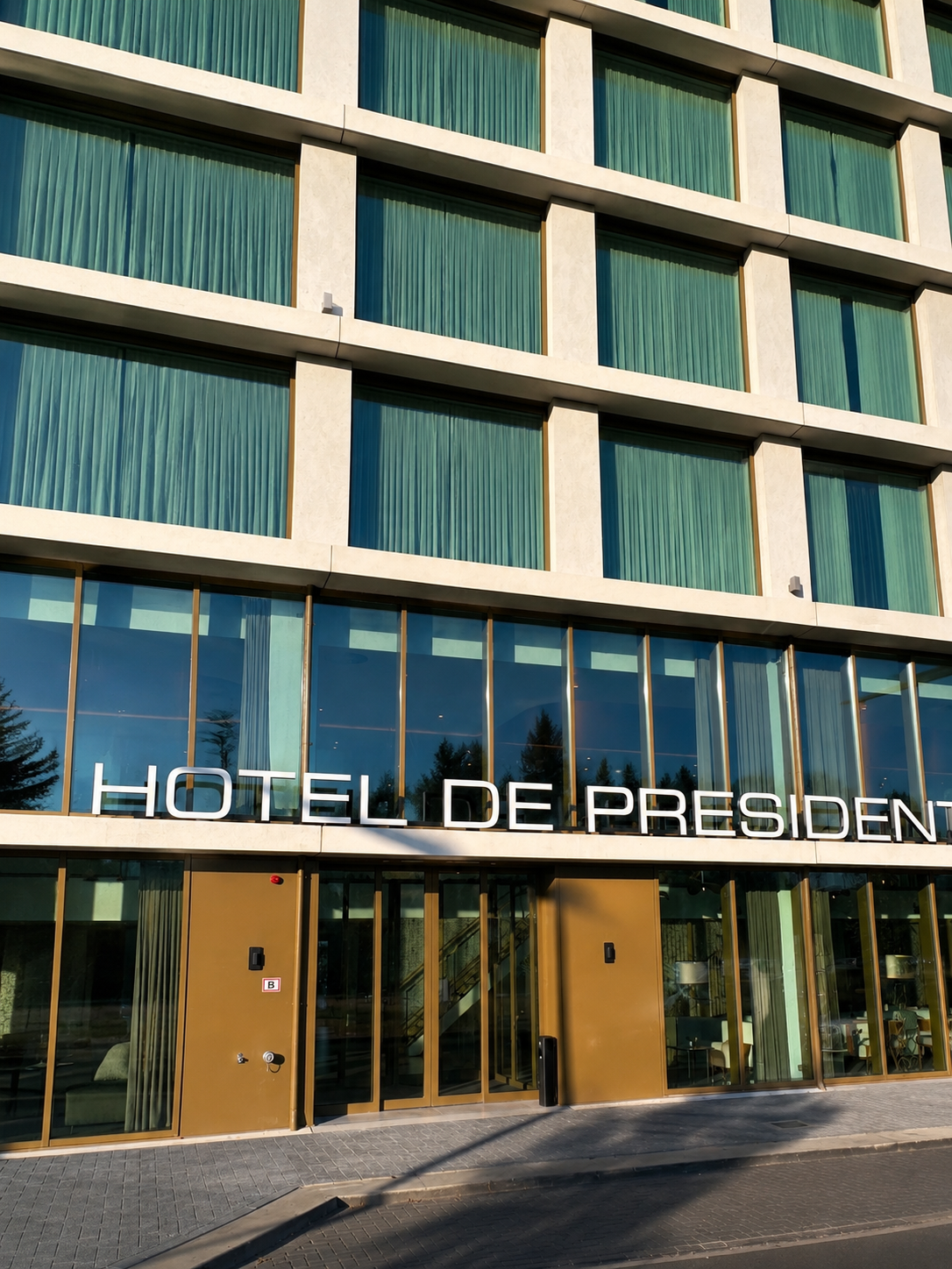 Modern hotel entrance with striking glass façade and welcoming exterior