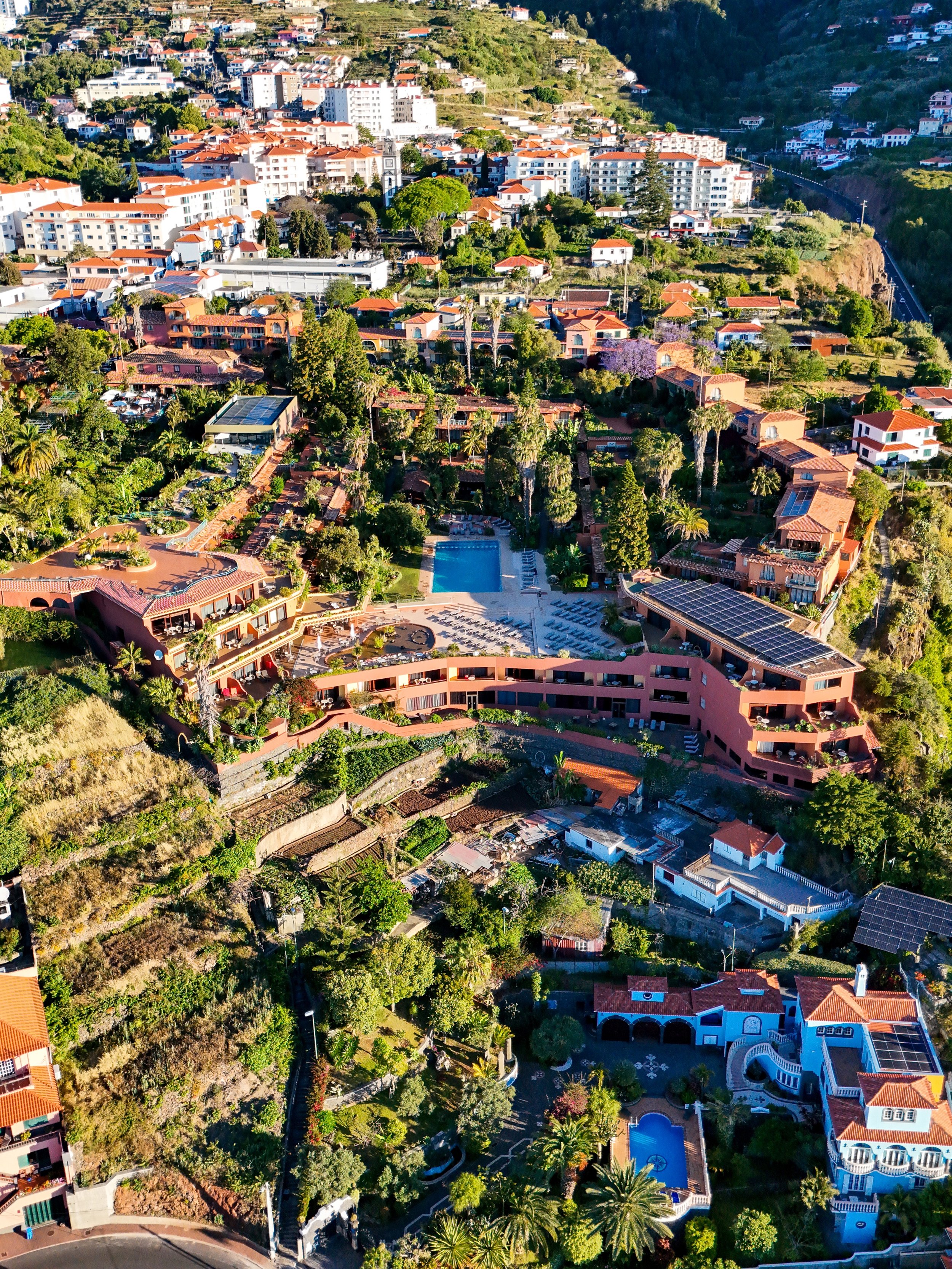 Aerial view showcasing the wellness resort, botanical gardens, and surrounding Madeira landscape