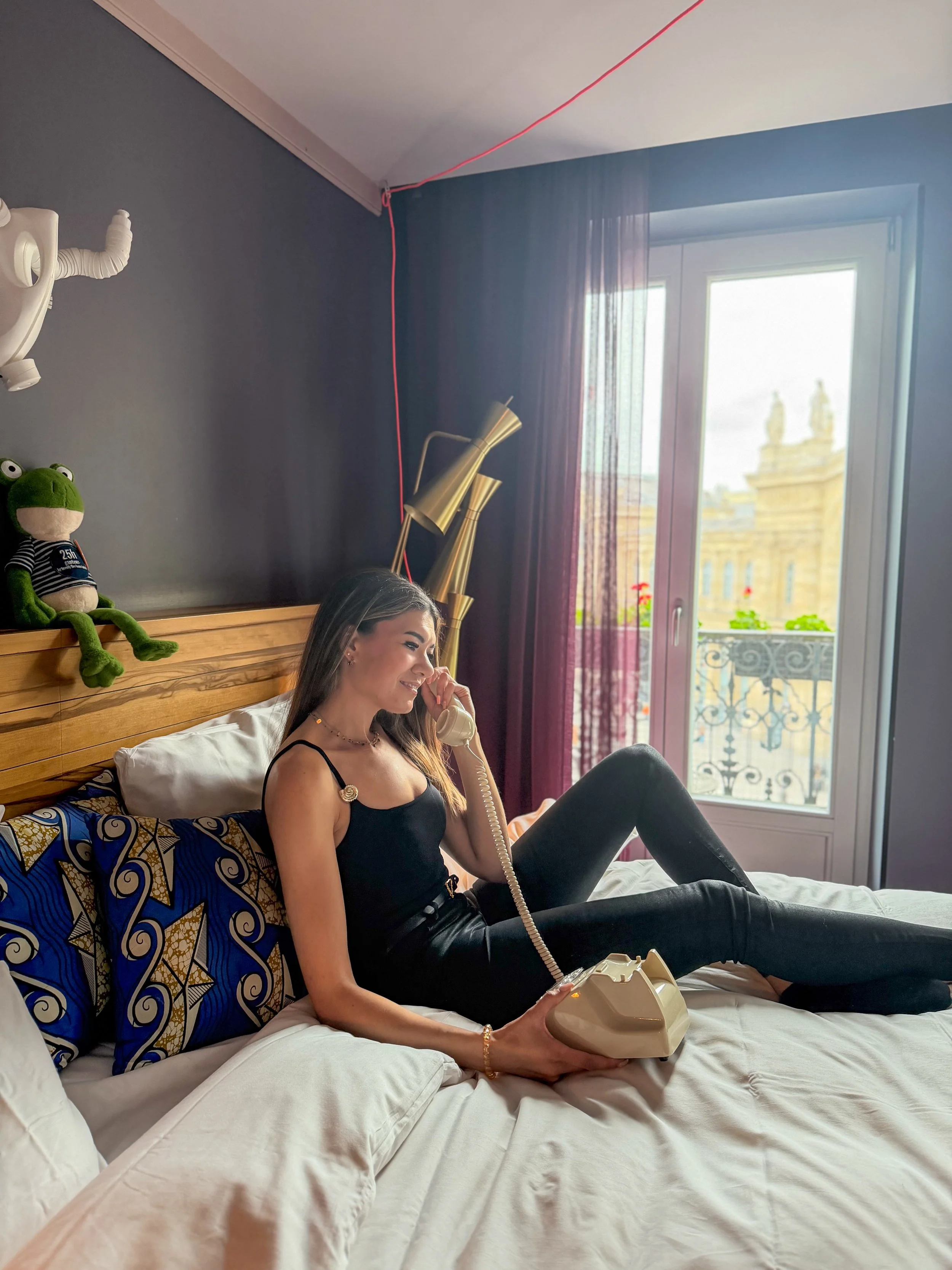 Modern guest room with vintage telephone and panoramic city views