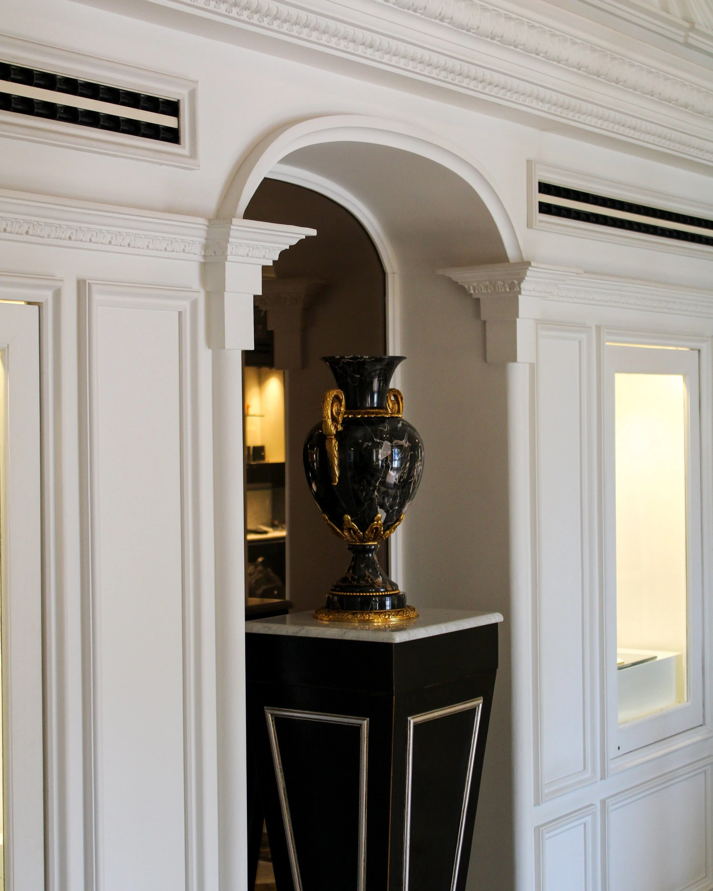 Historic architectural details with marble pedestal and decorative urn