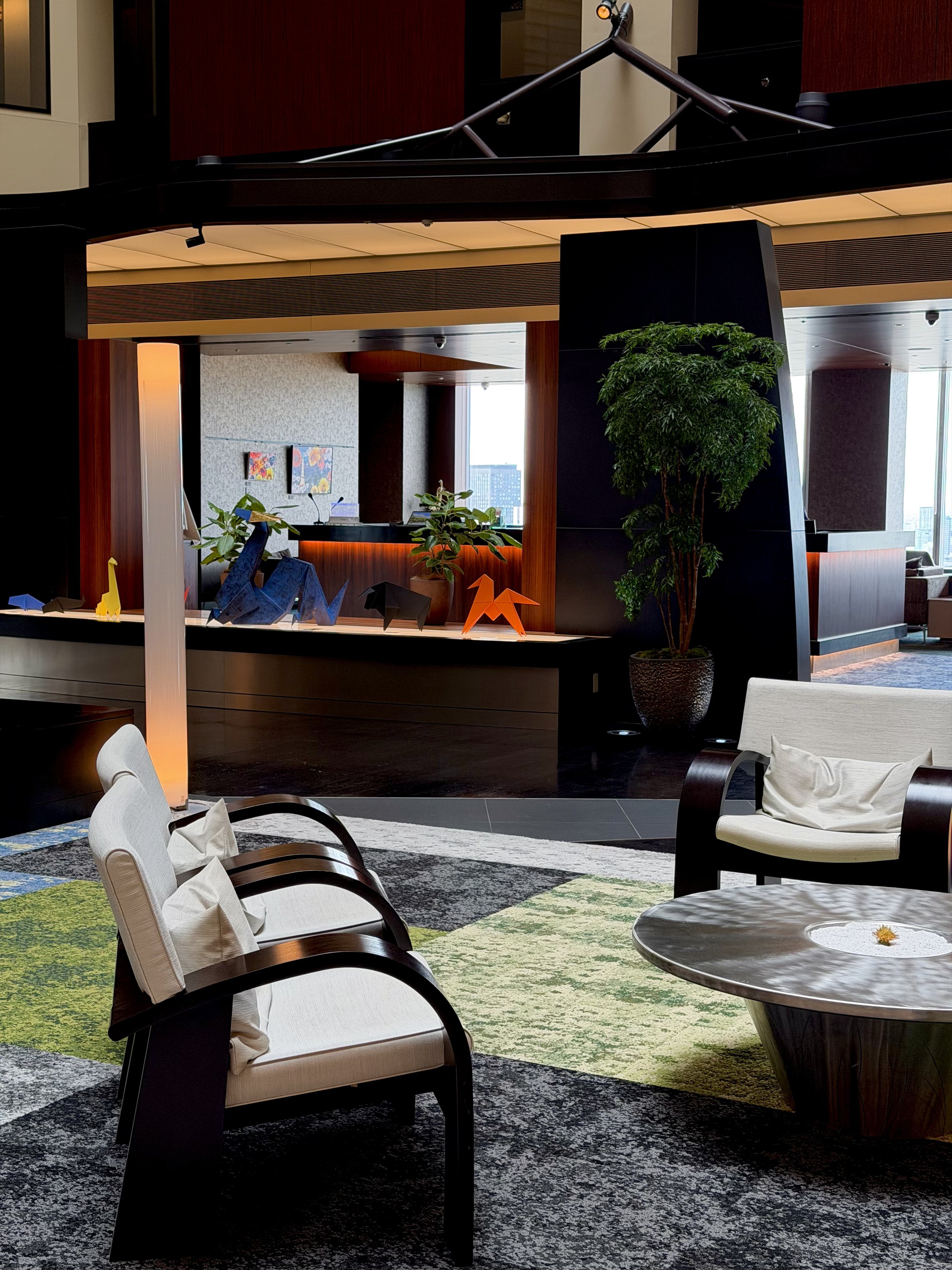 Guest relaxing in an indoor pool with panoramic views across snowy mountains, Ushuaia, and the Beagle Channel