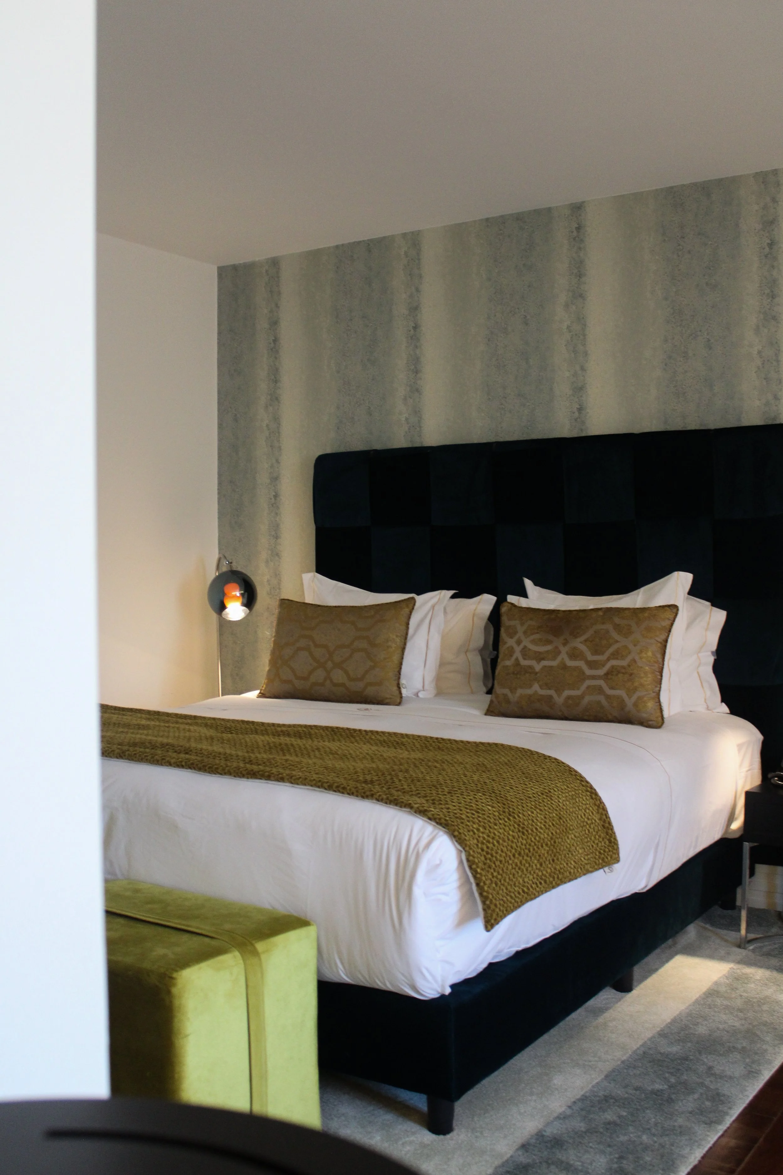 Elegant guest room with a plush king-size bed and sophisticated modern design