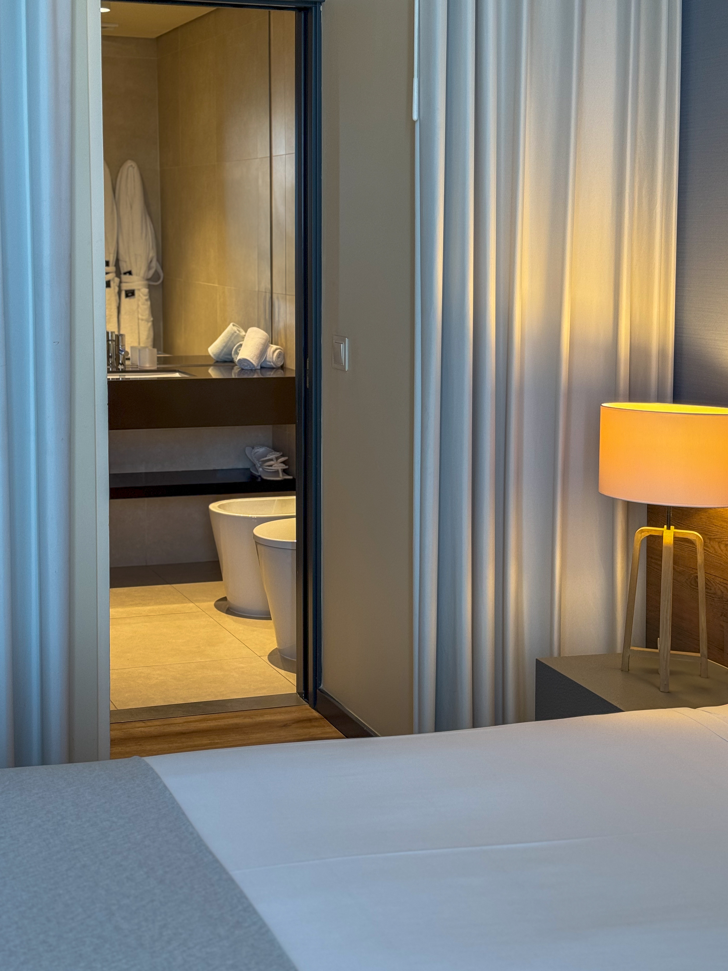 Modern guest room with open-plan bathroom and minimalist design