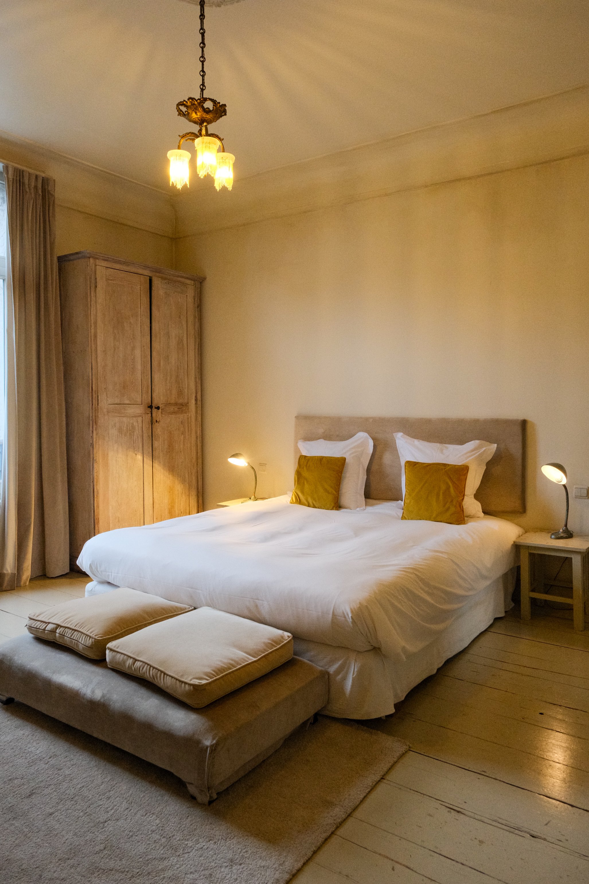 Elegant boutique bedroom with king bed and warm heritage interiors