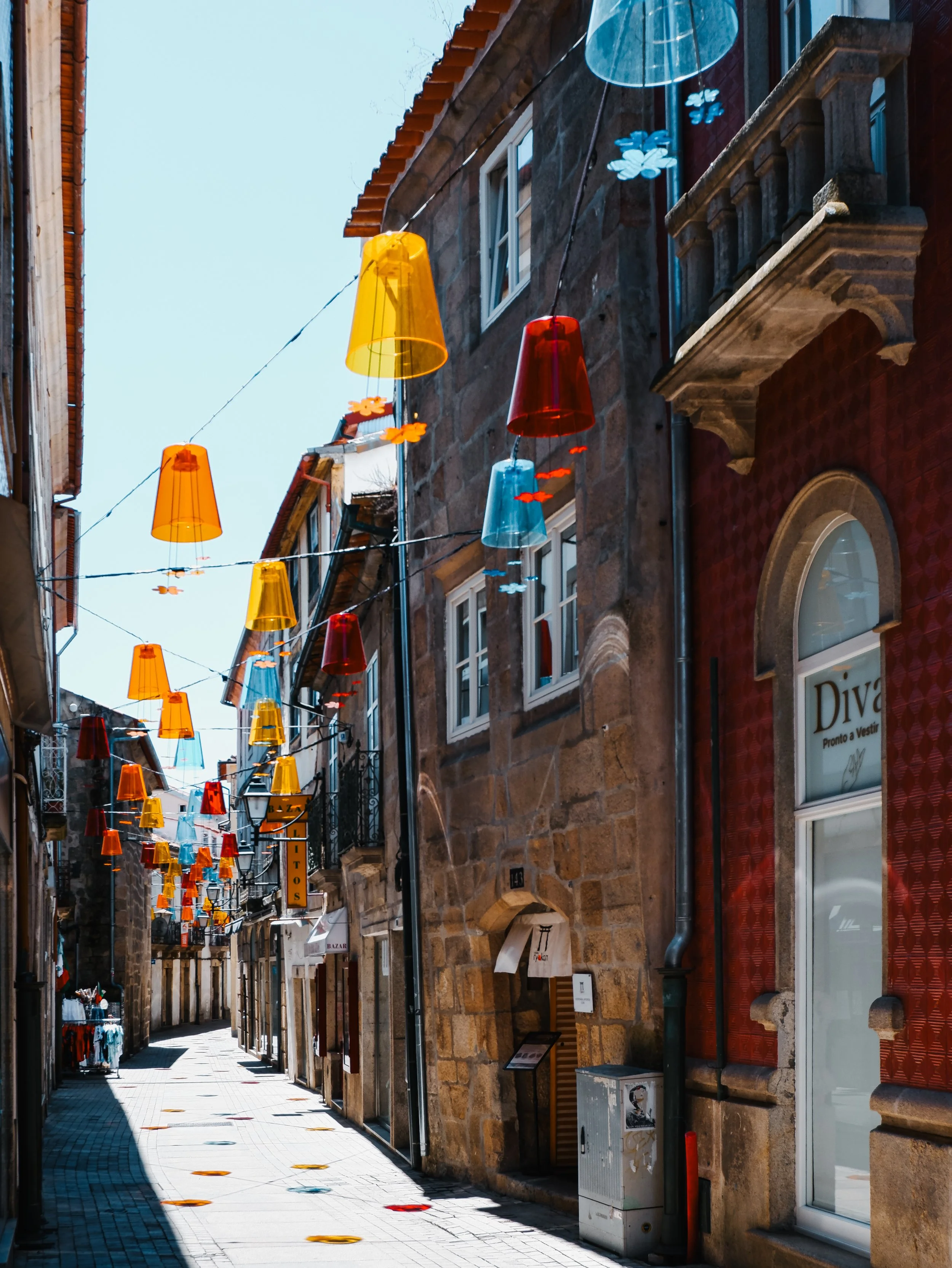 Historic street in Viseu decorated with colourful suspended lanterns near the boutique hotel