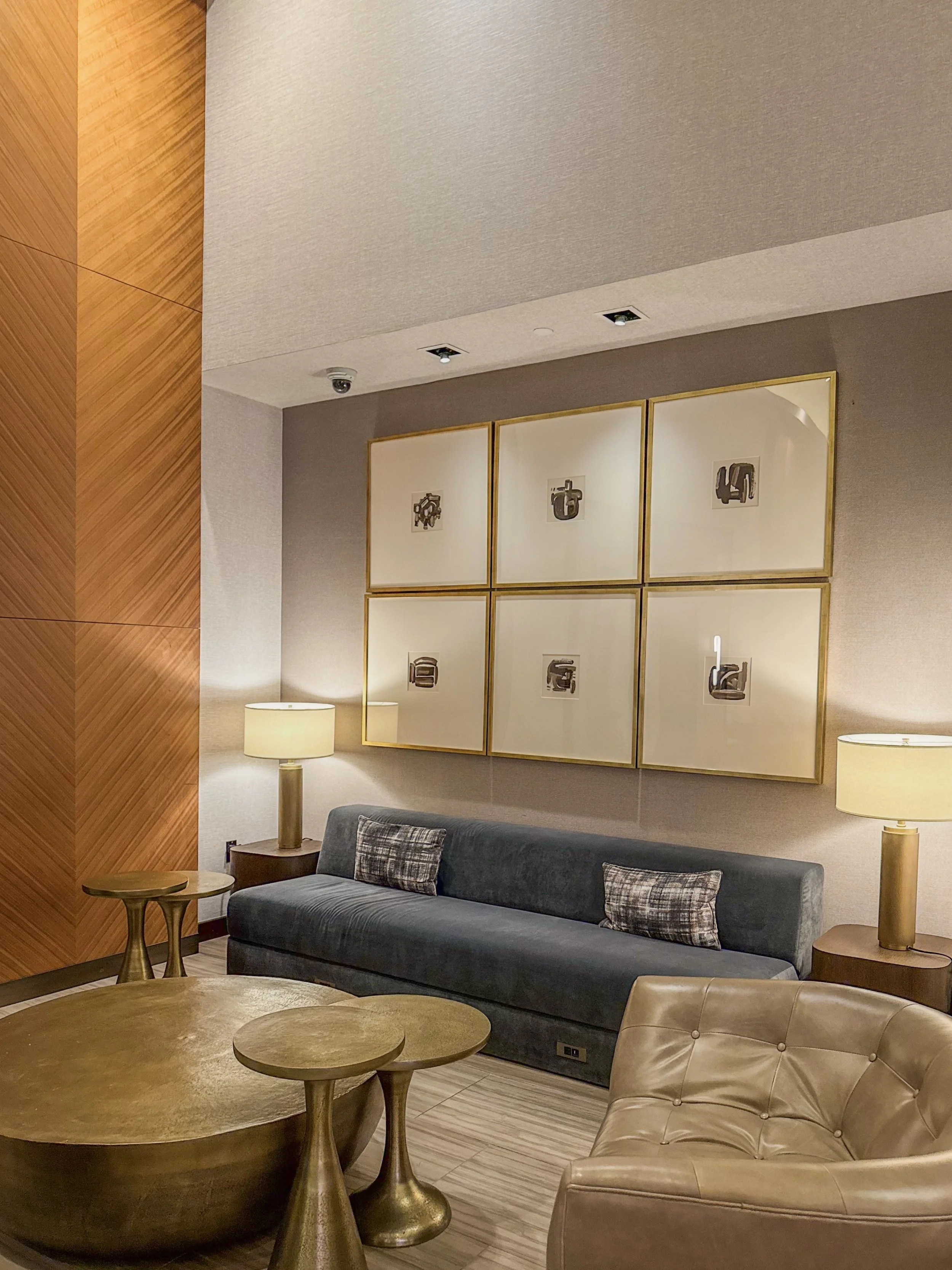 Contemporary lounge with comfortable seating, warm lighting, and framed artwork