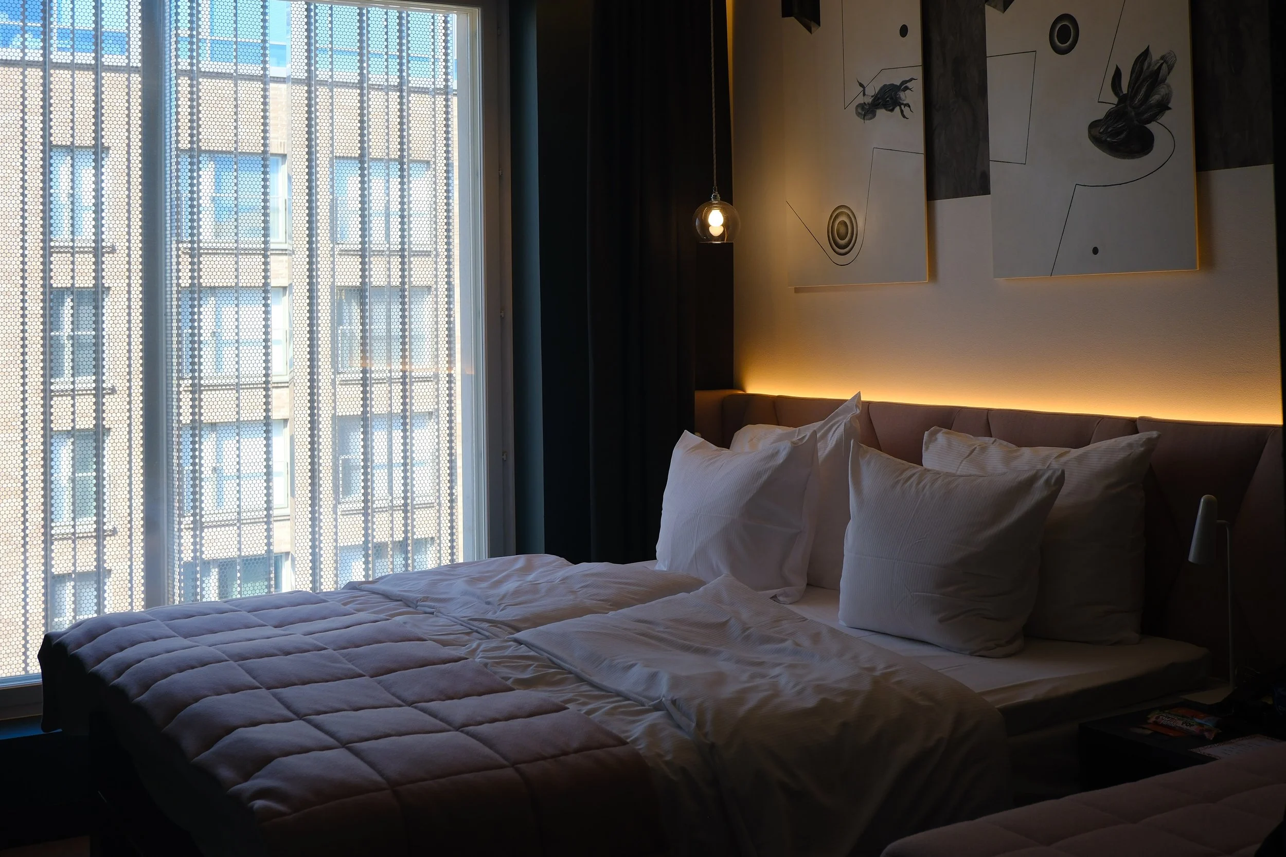 Modern guest room with designer furnishings and floor-to-ceiling windows