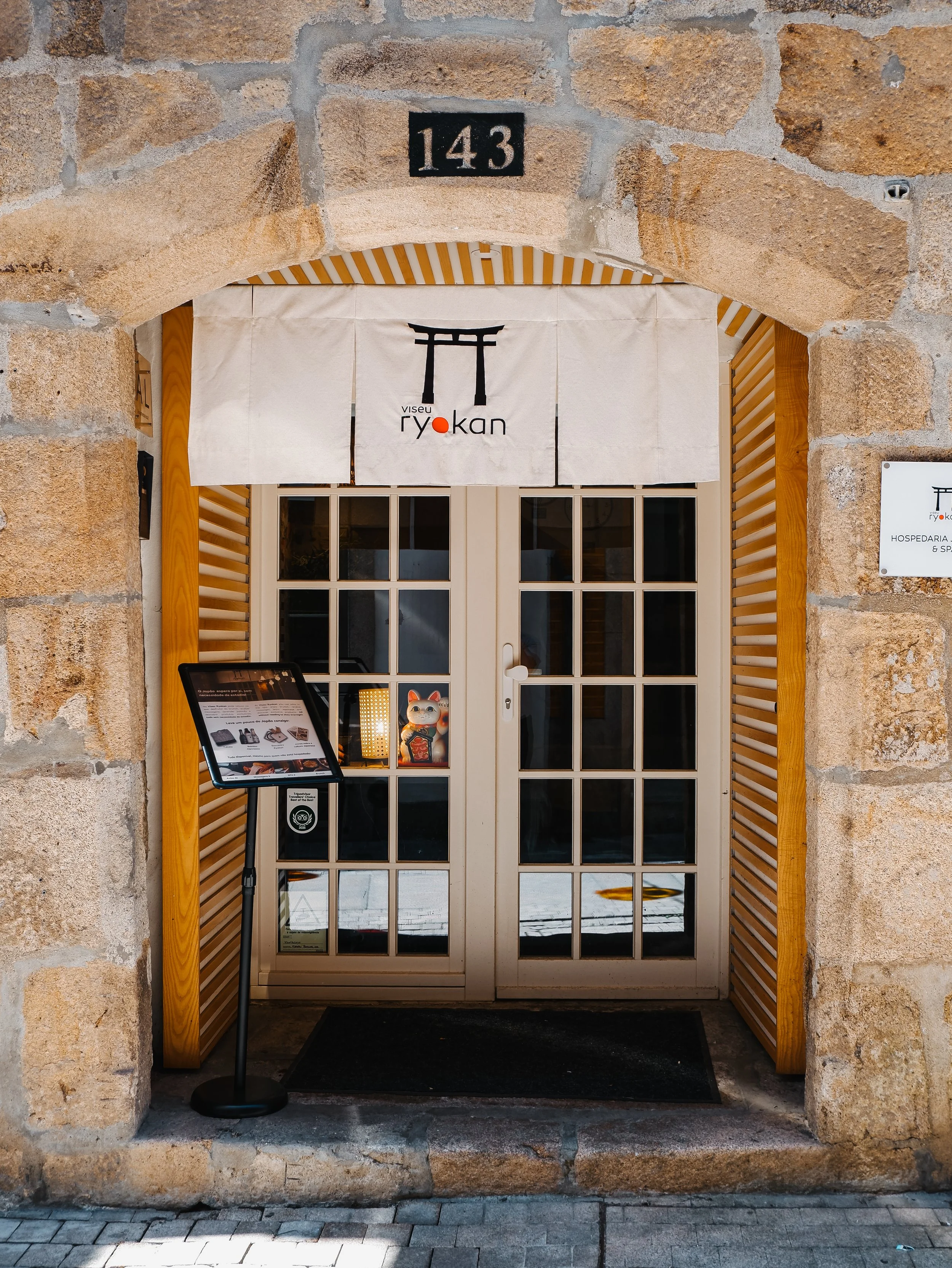 Traditional Japanese-inspired hotel entrance set within Viseu’s historic stone architecture