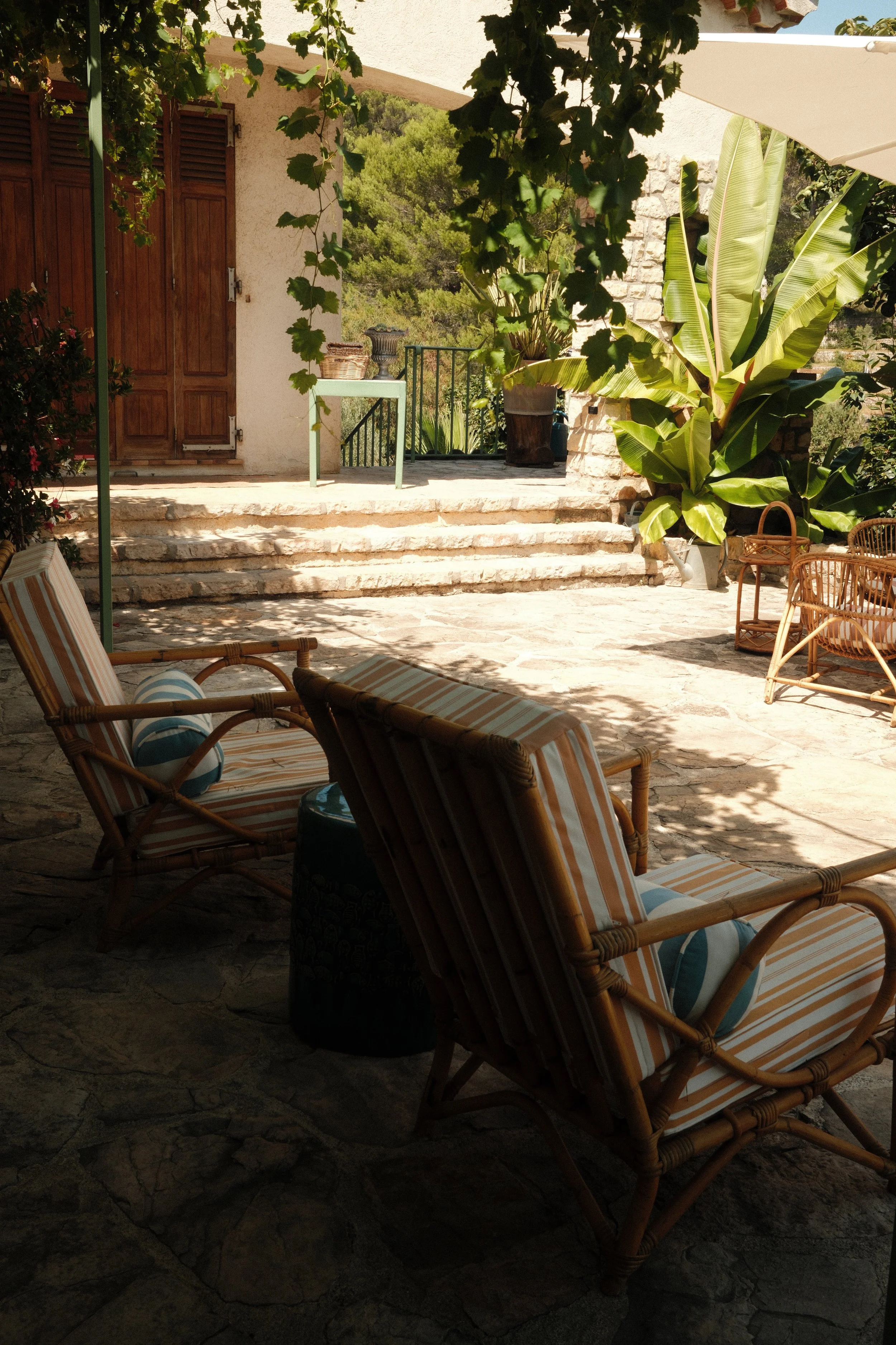 Relaxed terrace with natural stone, greenery, and quiet seating areas