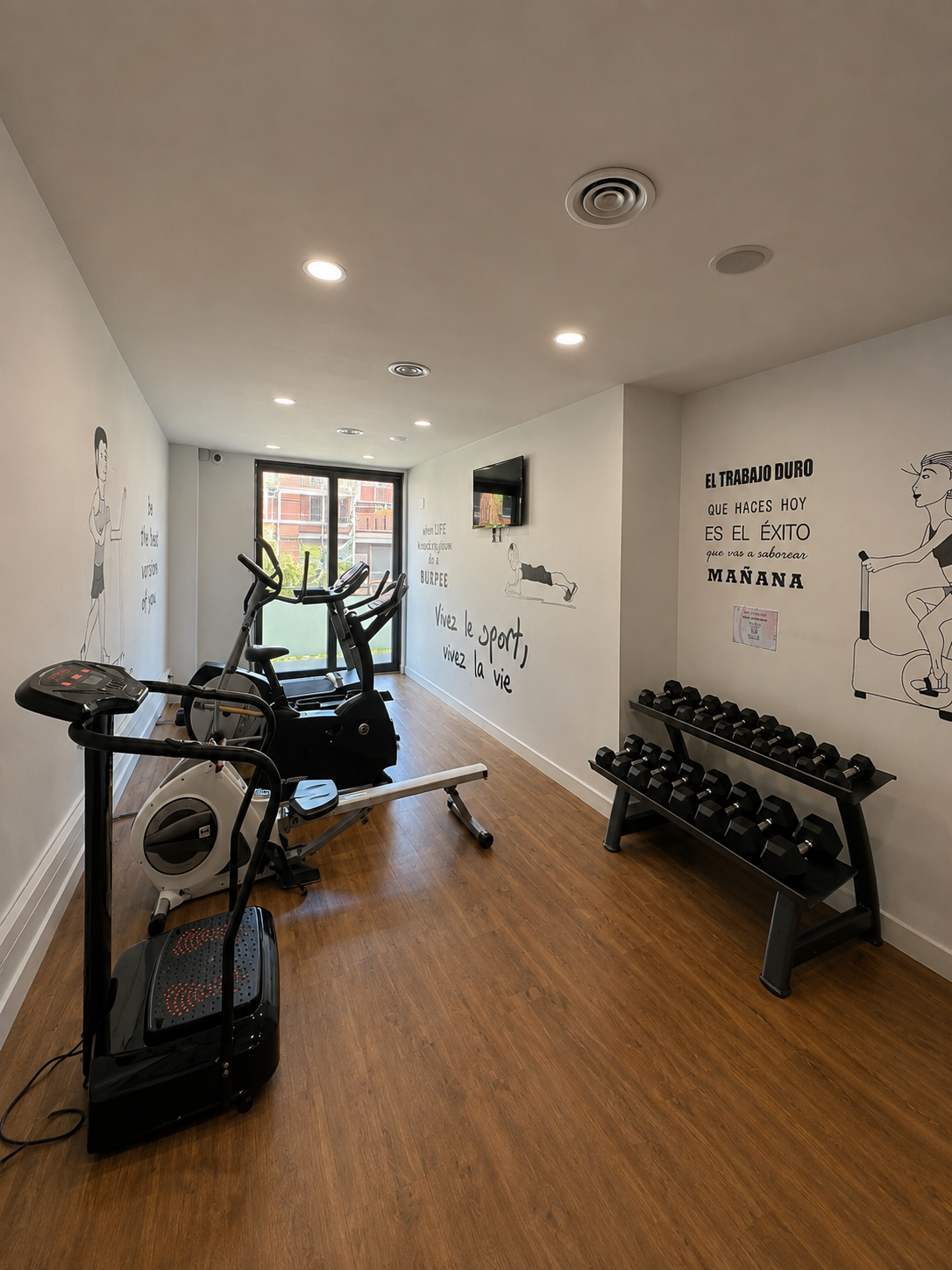 Fitness room equipped with cardio machines and free weights