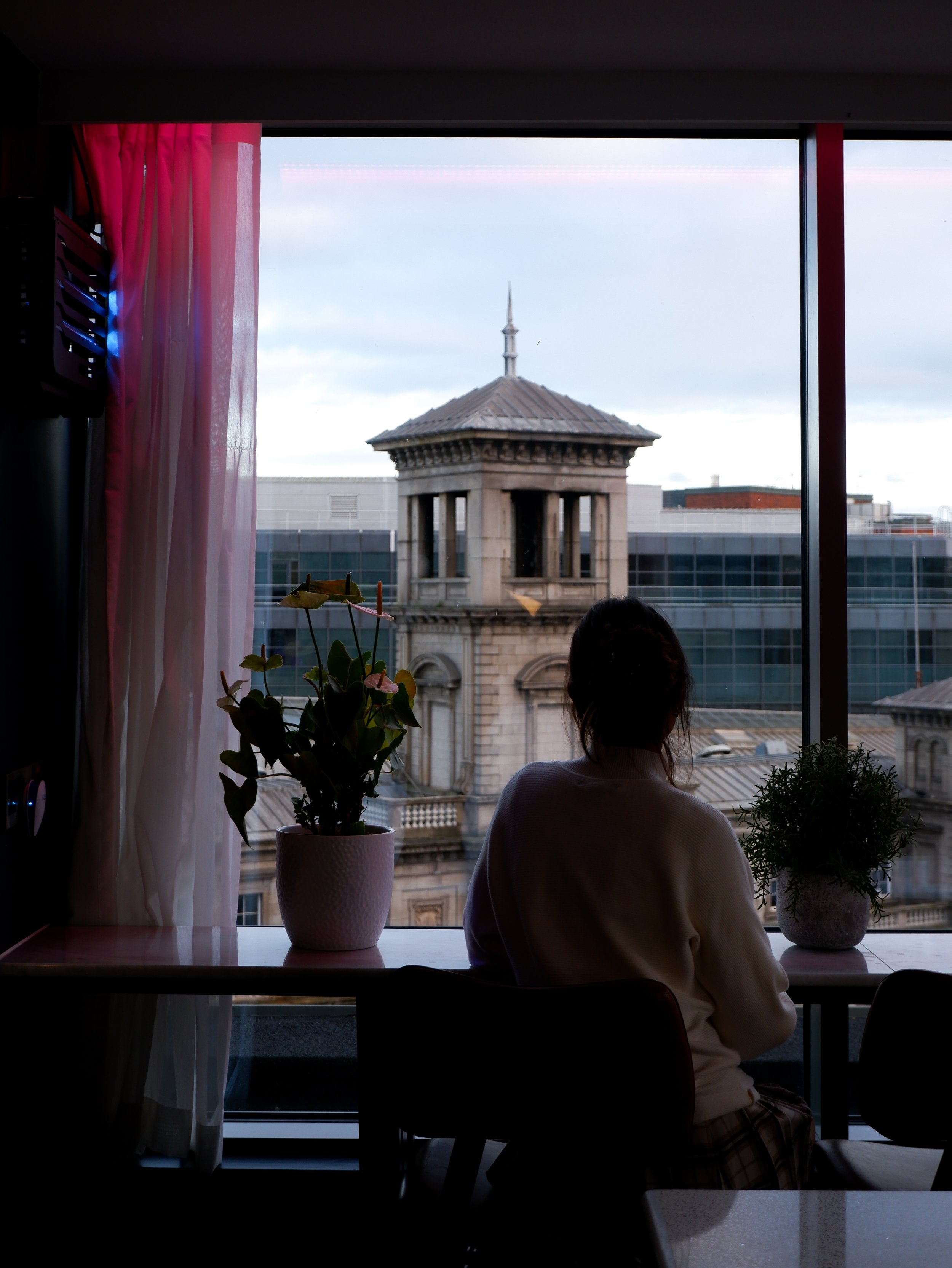 Guest enjoying views of Dublin's historic Connolly Station from a hotel window