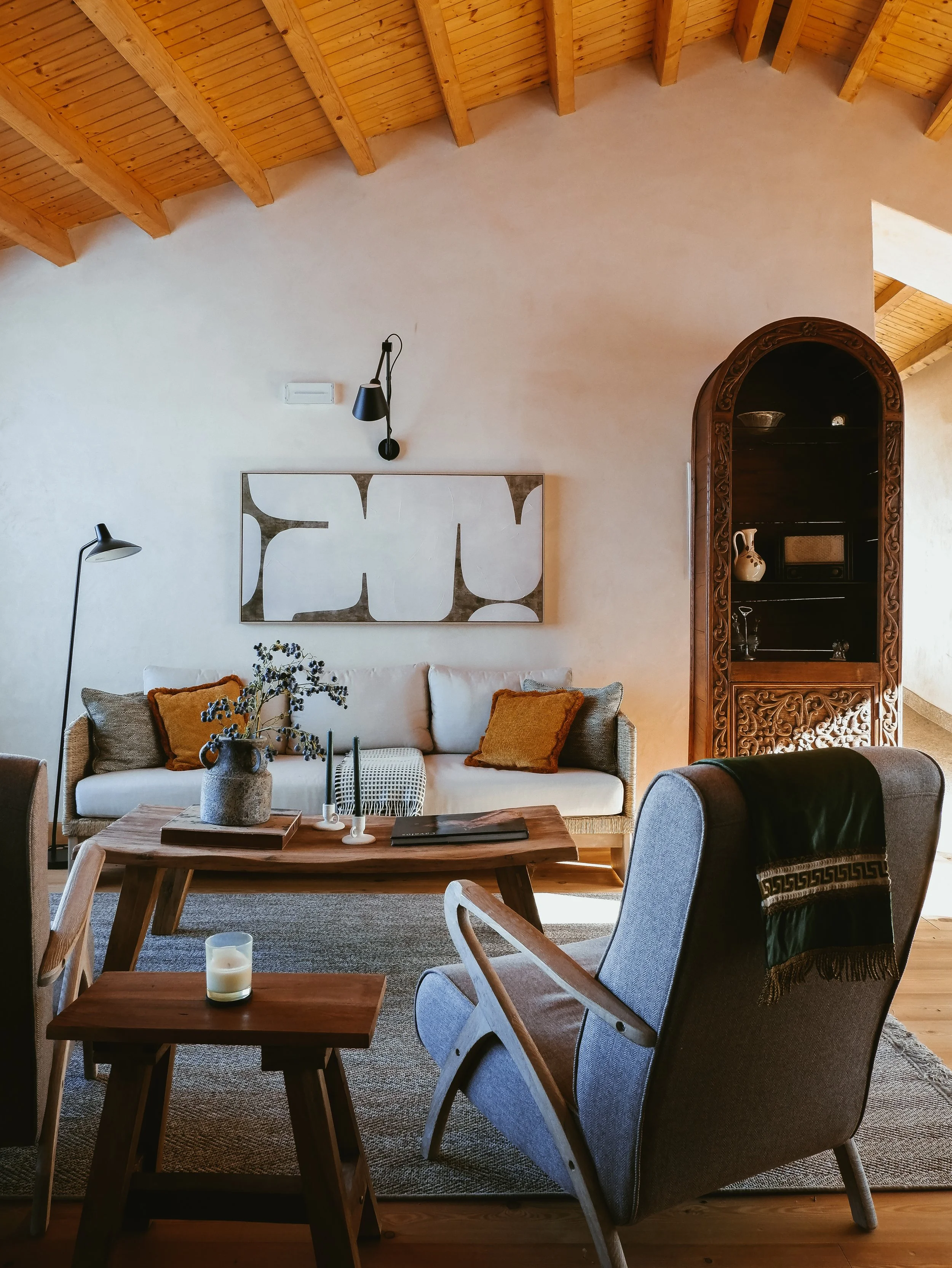 Inviting lounge with exposed wooden beams, contemporary furnishings, and handcrafted decorative details