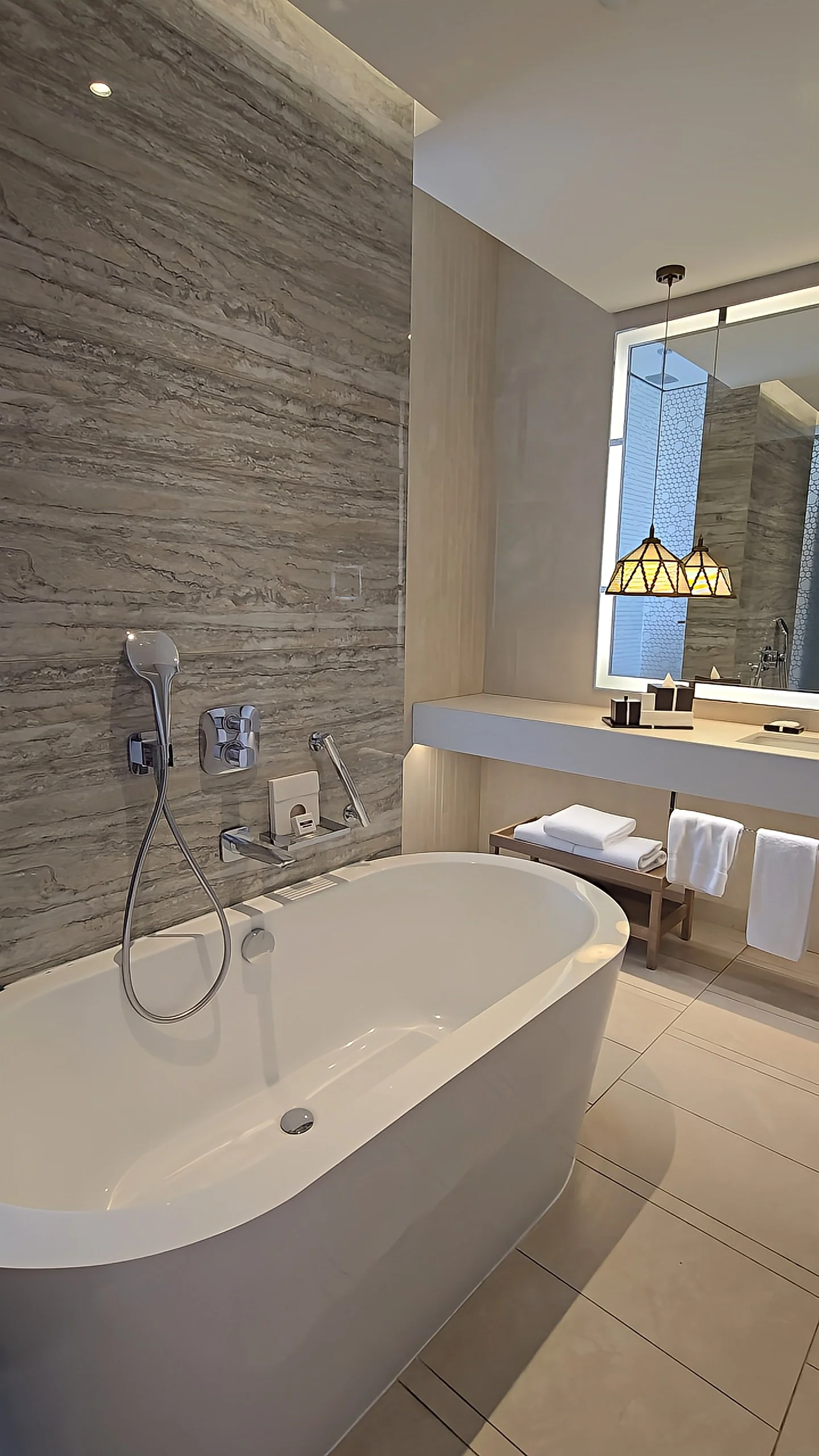 Modern marble bathroom with freestanding bathtub and warm ambient lighting, Hyatt Regency Aqaba Ayla Resort – Aqaba, Jordan.