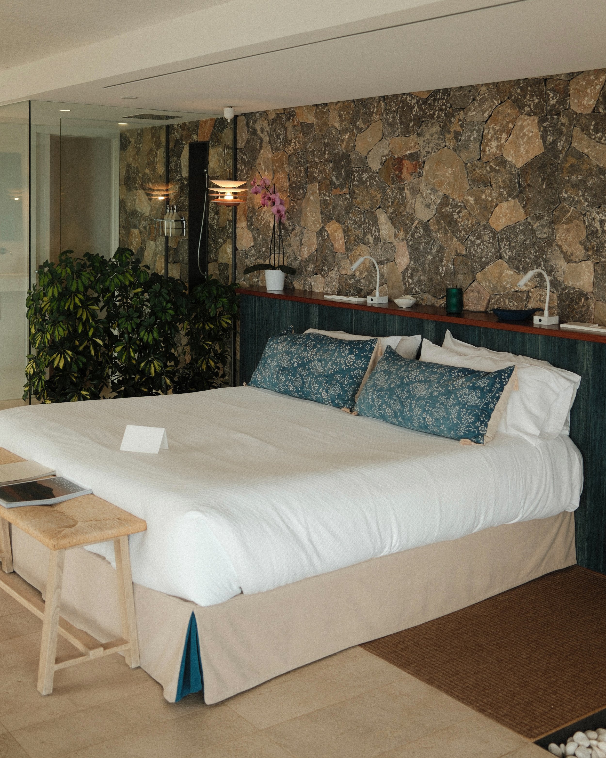 Elegant suite featuring natural stone walls, contemporary furnishings, and refined Mediterranean design
