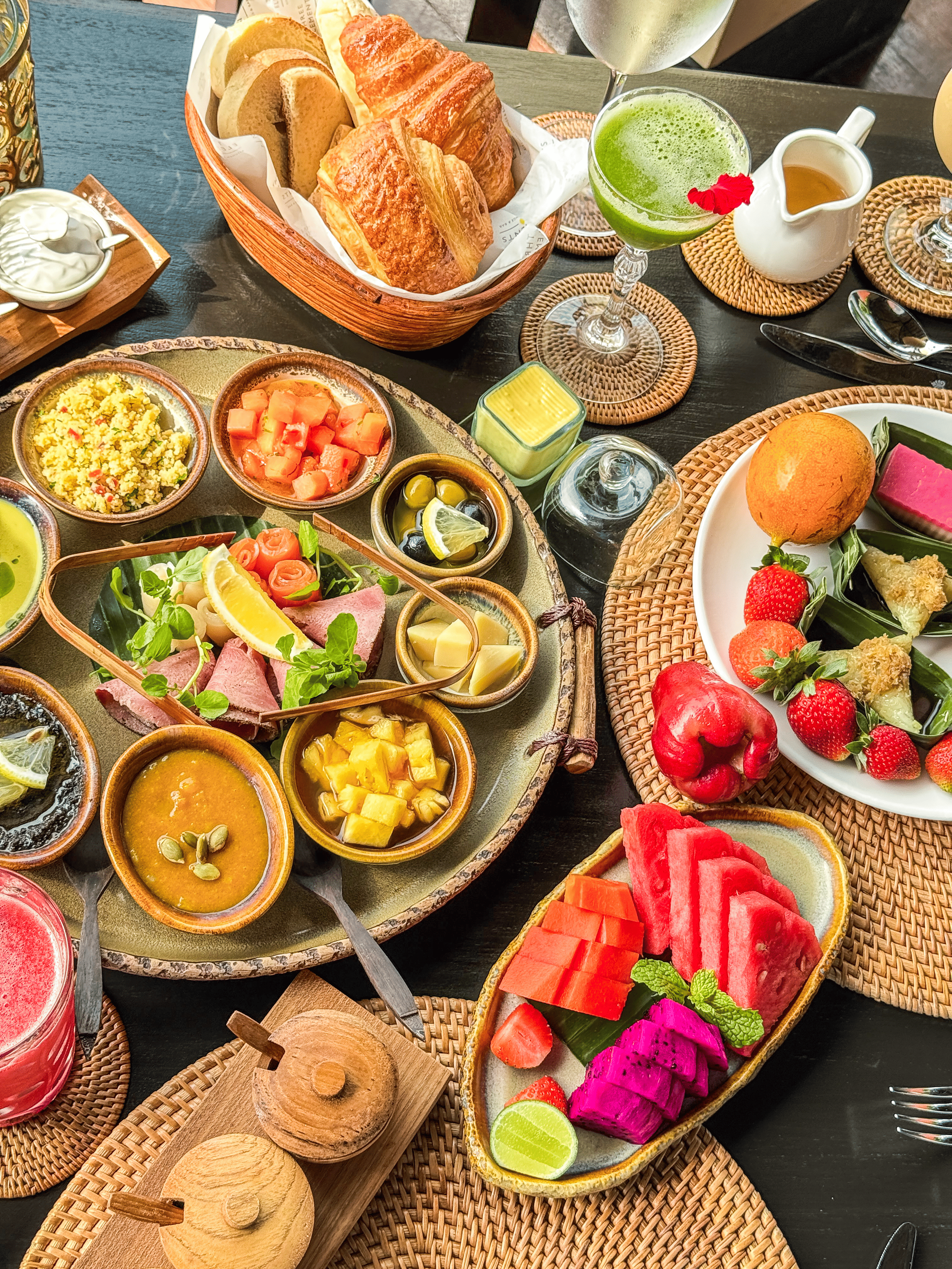 Abundant breakfast spread with tropical fruits and pastries at Hanging Gardens of Bali