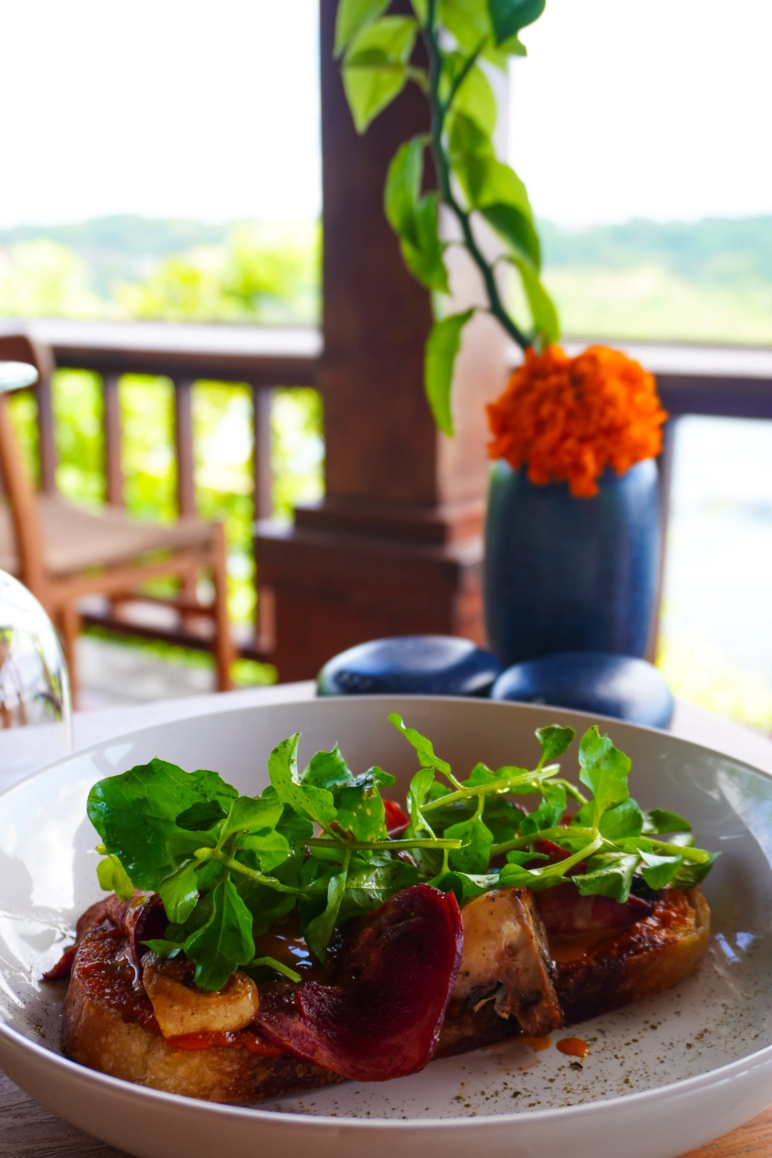 Gourmet dish with greens and grilled toppings served at Pramana Nusa Ceningan Resort Bali restaurant