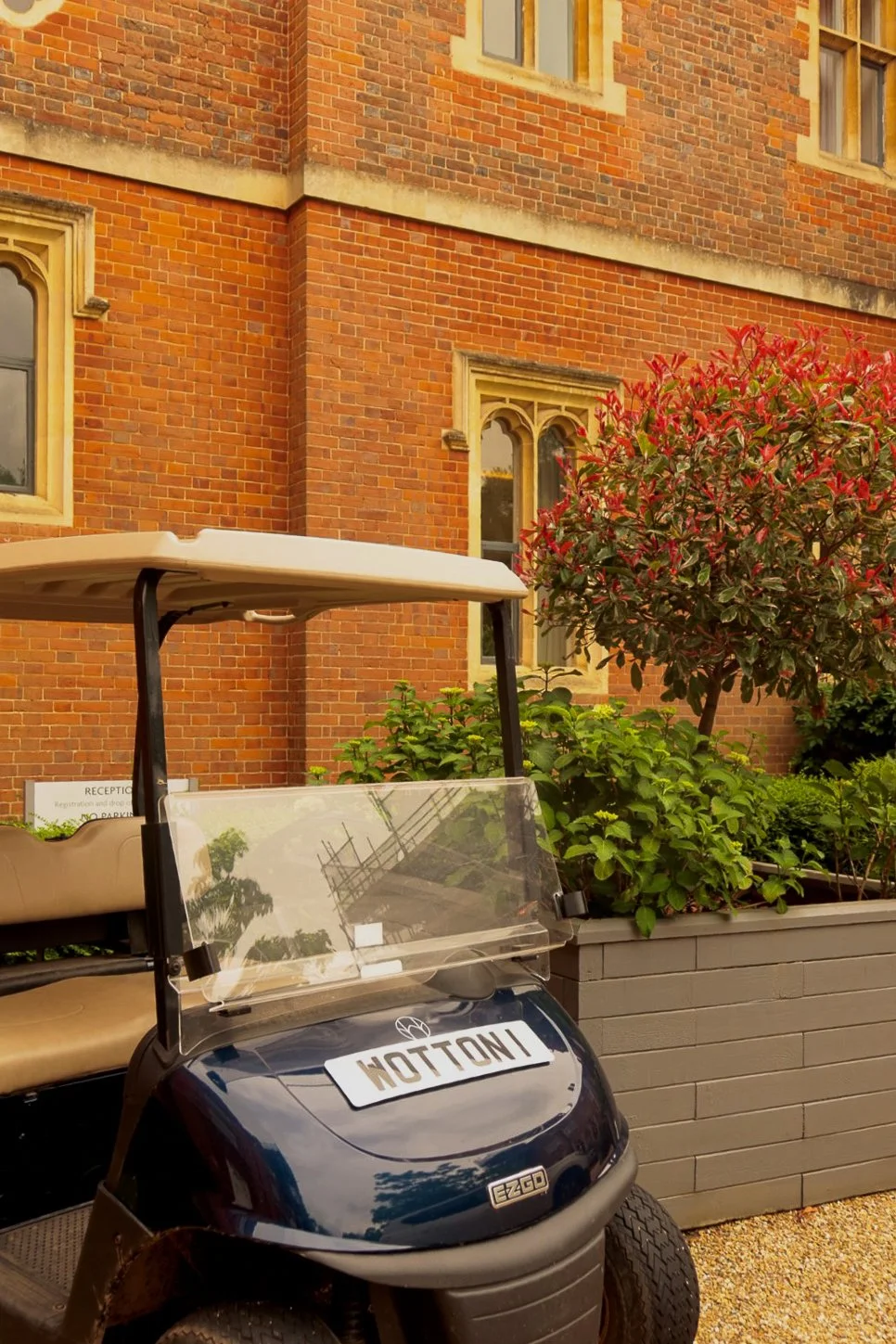 Wotton House estate buggy outside the historic red-brick country house in Surrey
