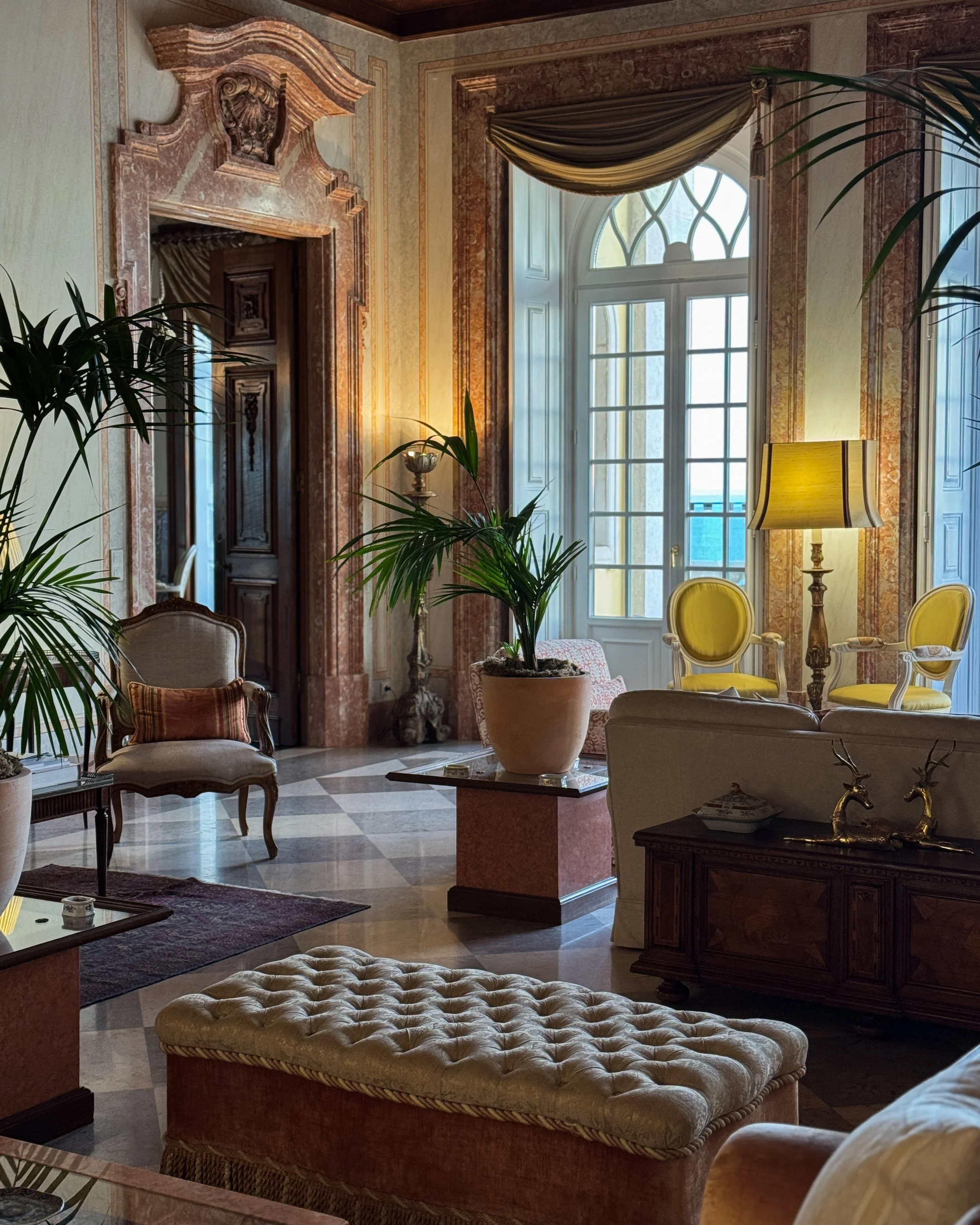 Elegant lounge with marble details, classic furnishings, and soft natural light creating a timeless atmosphere, Estoril Vintage Hotel – Estoril, Portugal.